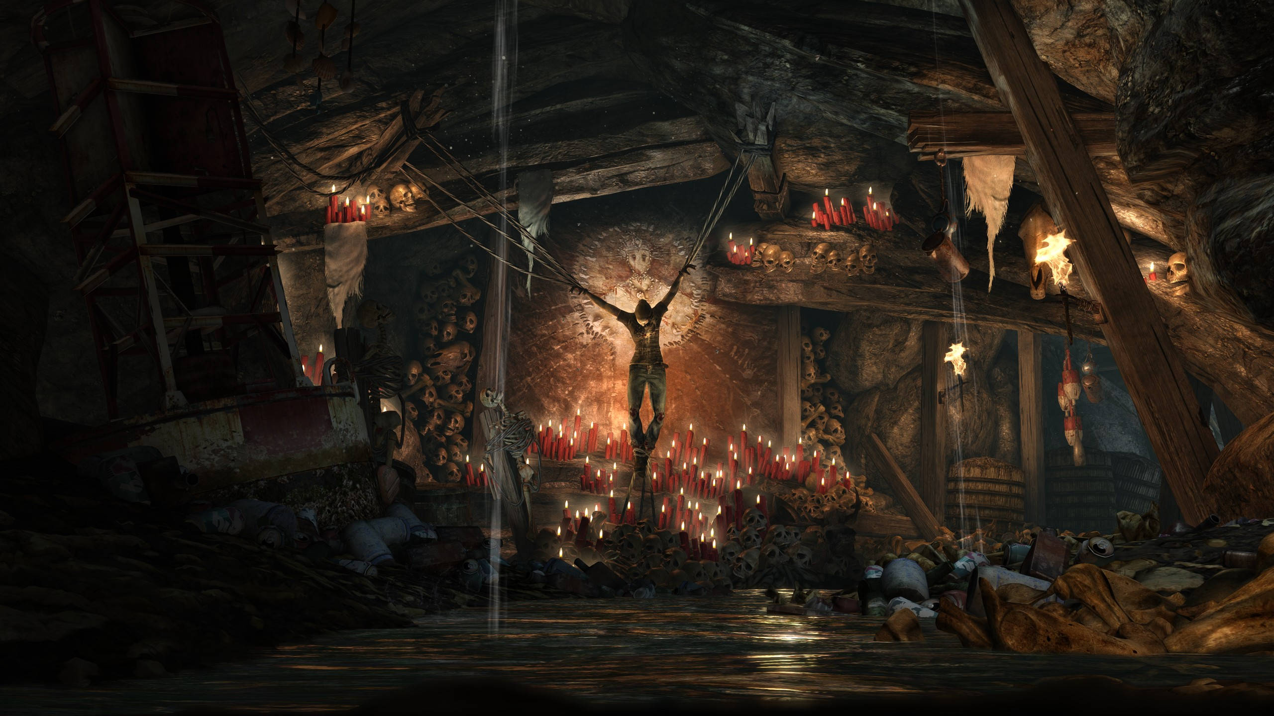 電玩遊戲 桌布 壁紙 — 一個人影懸掛在一個黑暗、燭光照亮的洞穴中，洞穴內佈滿頭骨和骸骨，營造出陰沉詭異的氣氛。