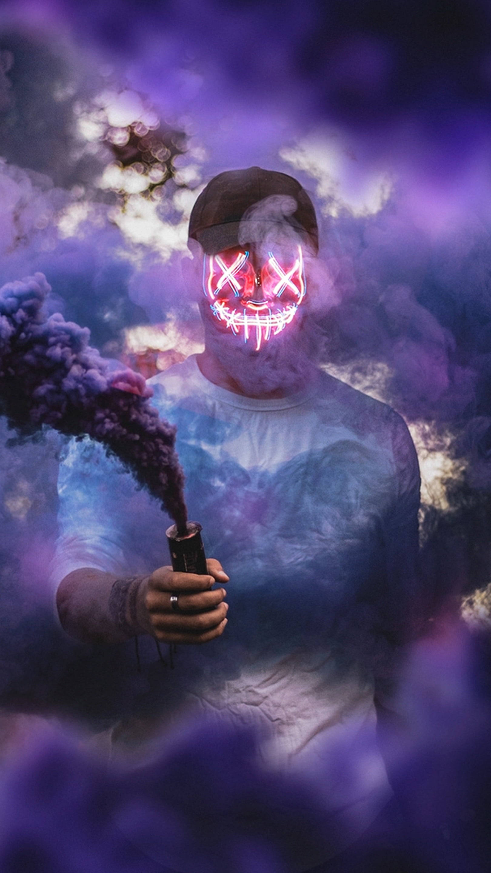 Purge 桌布 壁紙 — 一個人戴著發光的紅色LED面具，在夢幻般的暮色天空中呼出紫色煙霧。