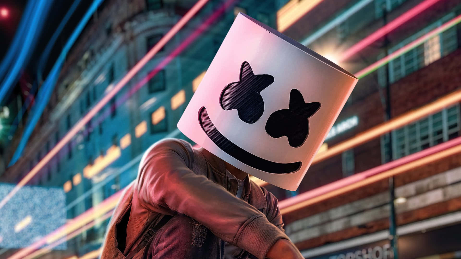 Marshmello 動態圖 桌布 壁紙 — 一個人戴著白色棉花糖面具，眼睛呈星形，站在霓虹燈照亮、有彩色光線流動的都市夜景中。