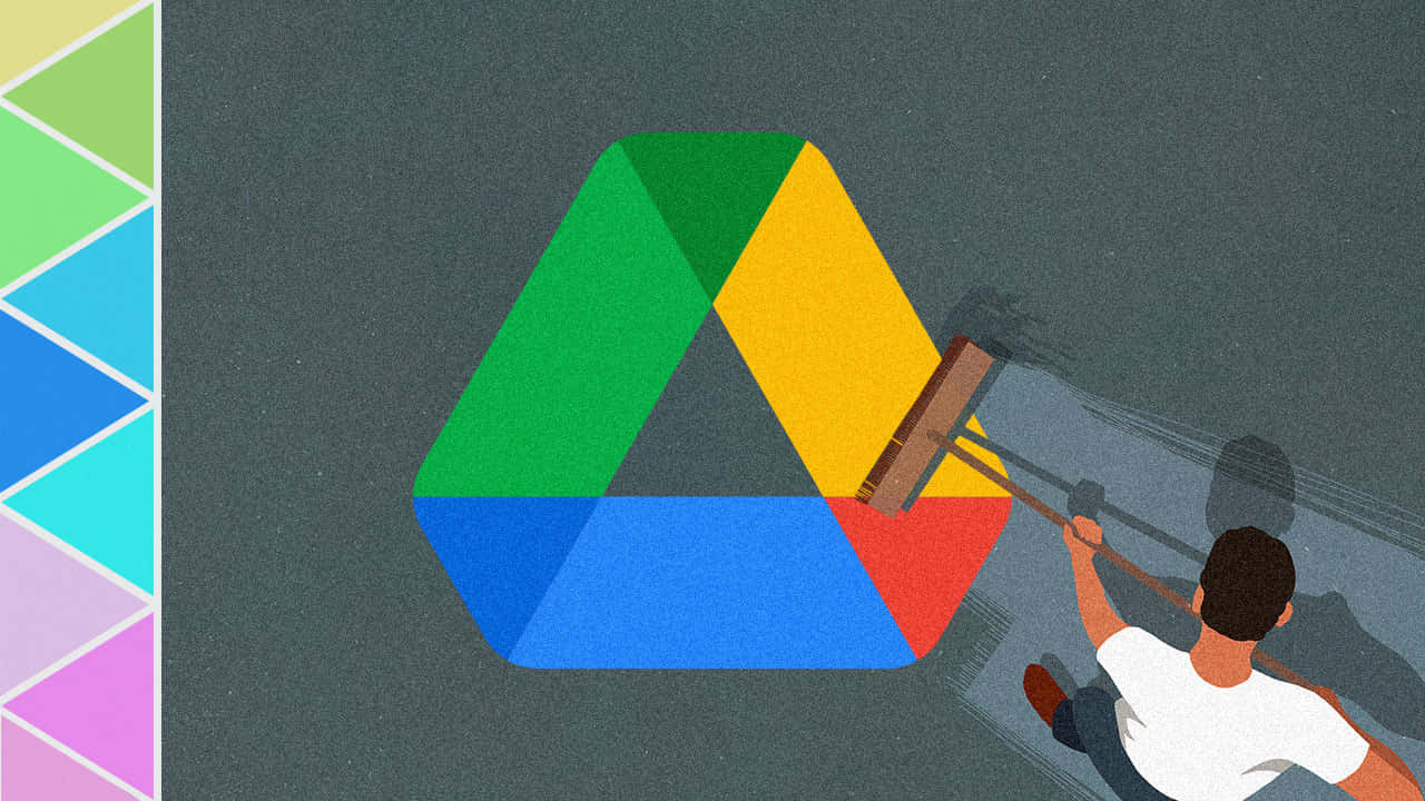 Google Drive 桌布 壁紙 — 一個人用掃帚在灰色地板上清掃一個大型彩色Google Drive標誌。