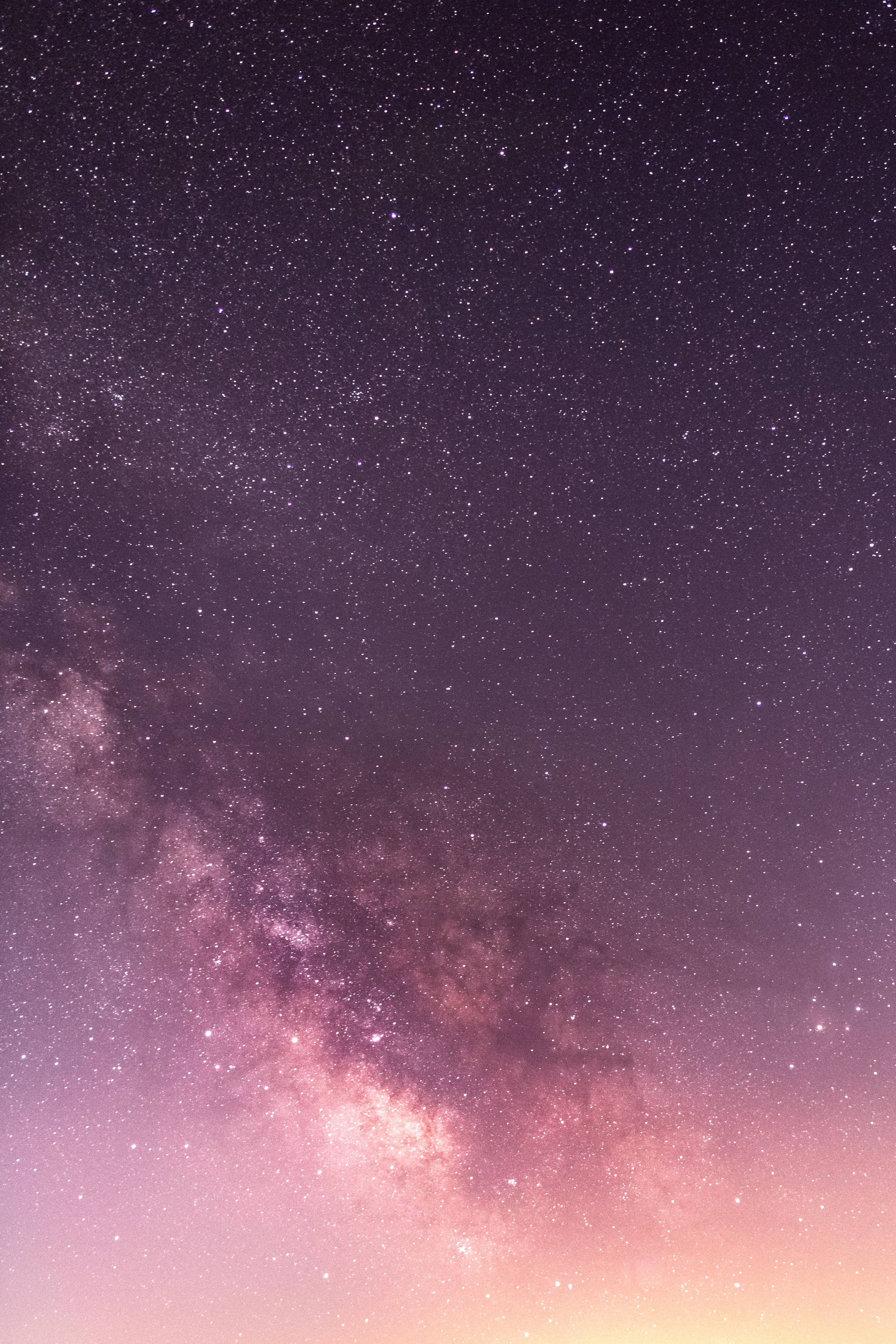 Gradient 桌布 壁紙 — 一個令人嘆為觀止的夜空，充滿無數星星和一條充滿活力的粉紫色銀河橫跨天際。