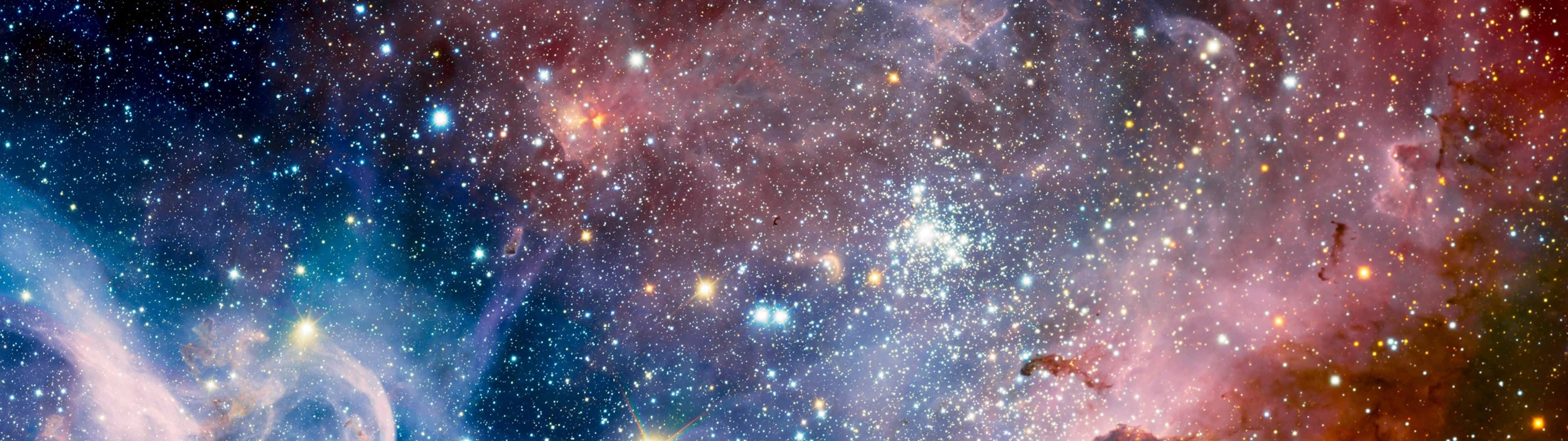 銀河 桌布 壁紙 — 一個令人嘆為觀止的宇宙全景，展示出旋轉的星雲，散發著粉紅色、橙色和藍色的光芒，無數星星散落在深邃的太空之中。