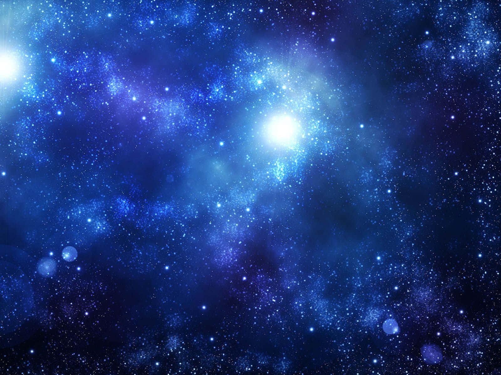 藍色銀河 桌布 壁紙 — 一個令人嘆為觀止的宇宙場景，充滿了發光的藍色星星和旋轉的星雲，背景是深邃的太空。