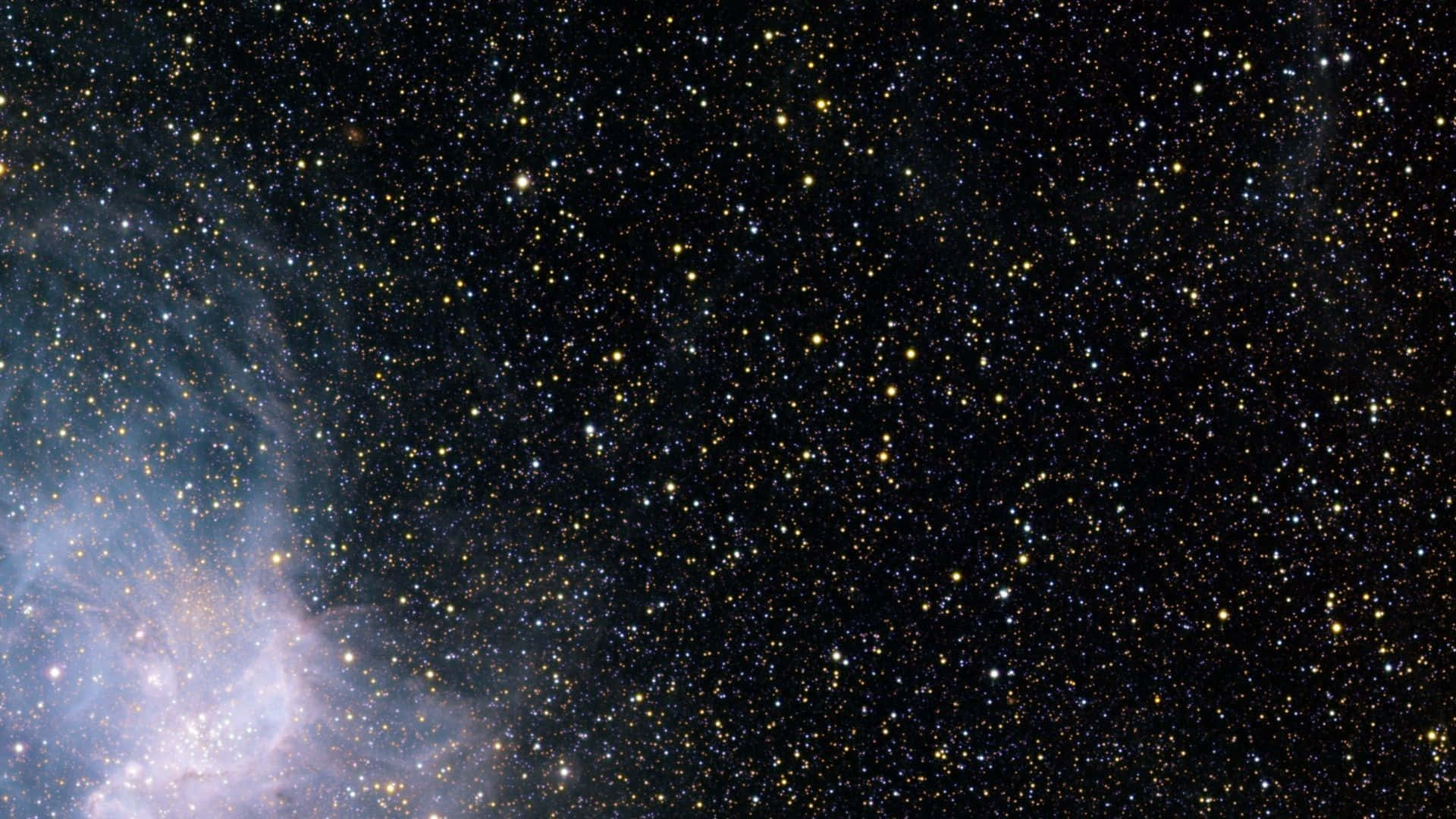 星星動圖 桌布 壁紙 — 一個令人嘆為觀止的星空景觀，左下角有發光的藍色星雲在黑色宇宙背景中旋轉。