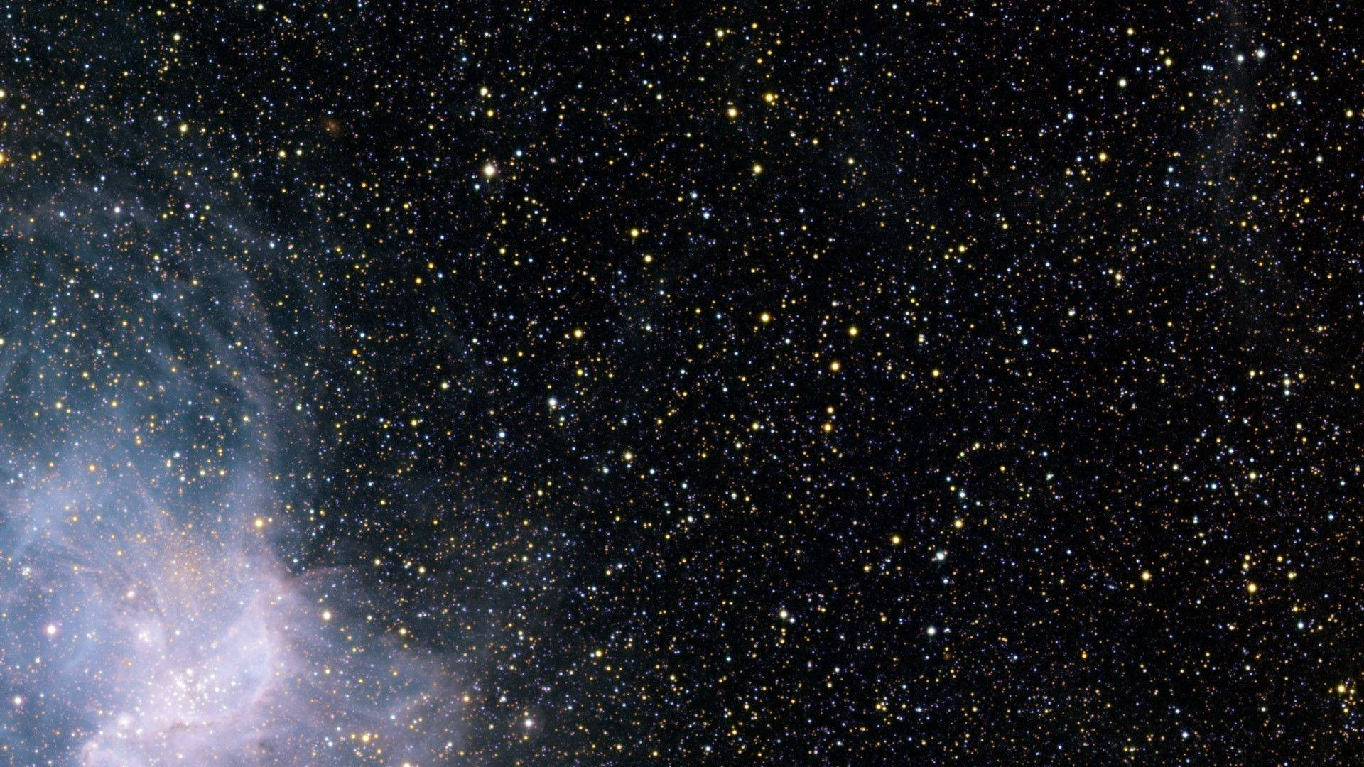 星星動圖 桌布 壁紙 — 一個令人嘆為觀止的星空景觀，左下角有一個發光的星雲，背景是深邃的黑色天空。