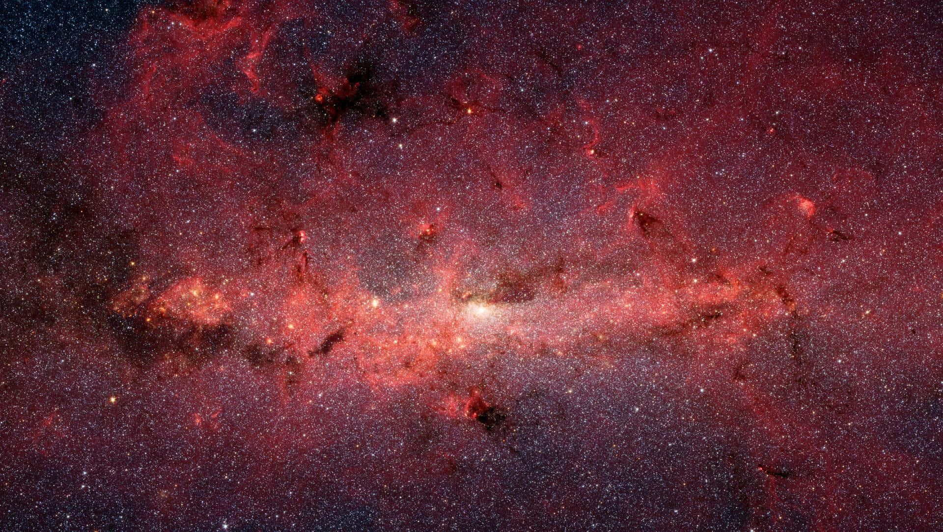 Red Galaxy 桌布 壁紙 — 一個令人嘆為觀止的景觀，充滿了發光的星星和宇宙塵埃的鮮豔紅色和橙色星雲，背景是黑暗的星空。