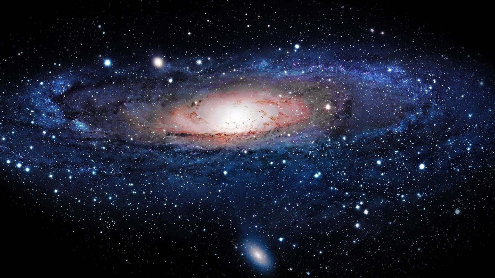 太空 桌布 壁紙 — 一個令人嘆為觀止的螺旋星系，在佈滿星辰的宇宙虛空中散發著藍色和粉紅色的光芒。
