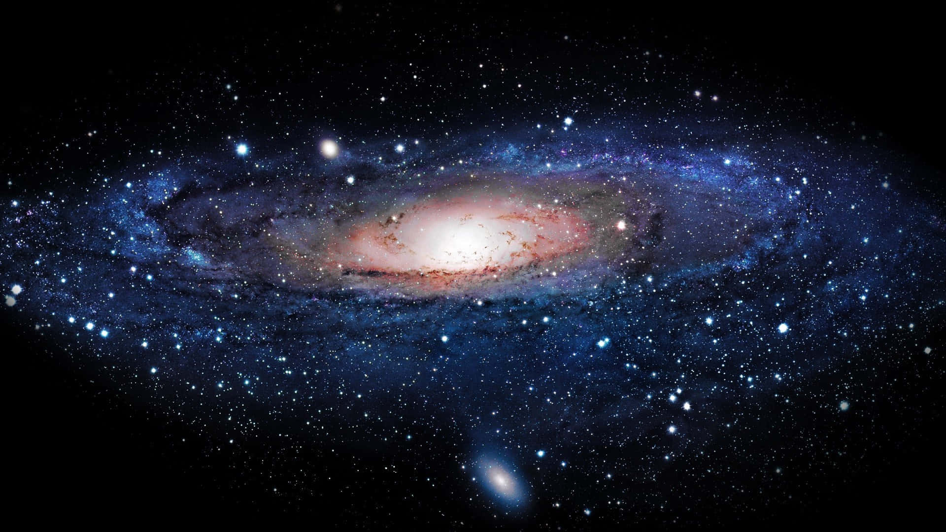 Space Desktop 桌布 壁紙 — 一個令人嘆為觀止的螺旋星系，在佈滿星星的黑色虛空中散發著藍色和粉紅色的光芒。