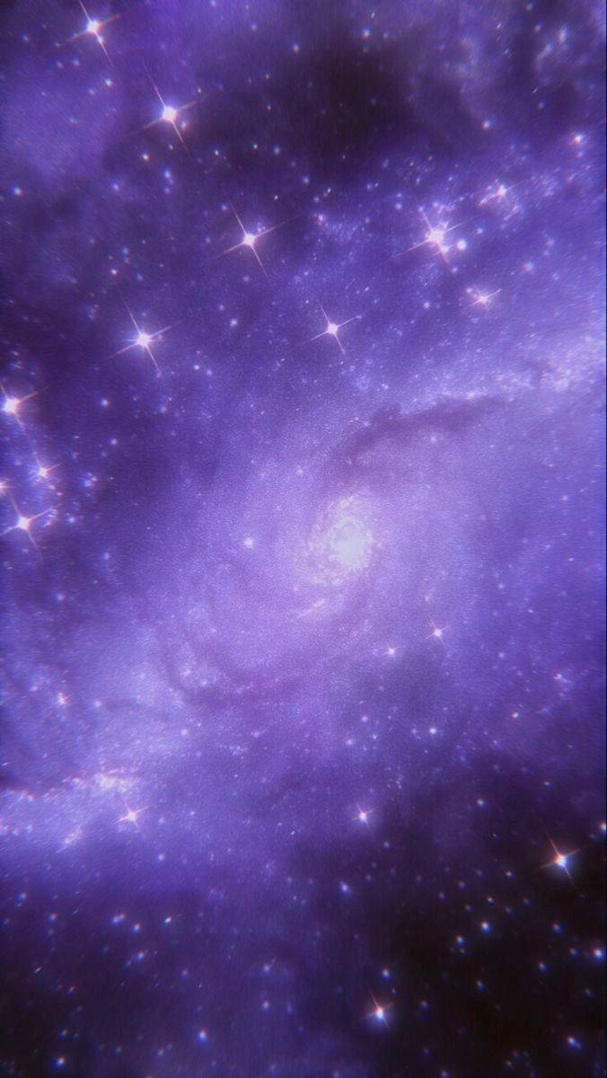 銀河 桌布 壁紙 — 一個令人嘆為觀止的螺旋星系，在宇宙虛空中散發著充滿活力的紫色星雲和閃爍的星星。