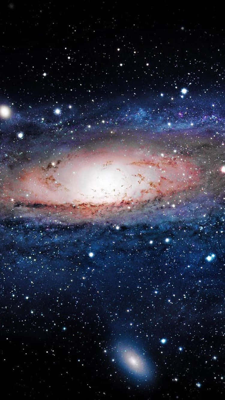 Beautiful Galaxy 桌布 壁紙 — 一個令人嘆為觀止的螺旋星系，在星空中閃耀著粉紅色和藍色的色調。