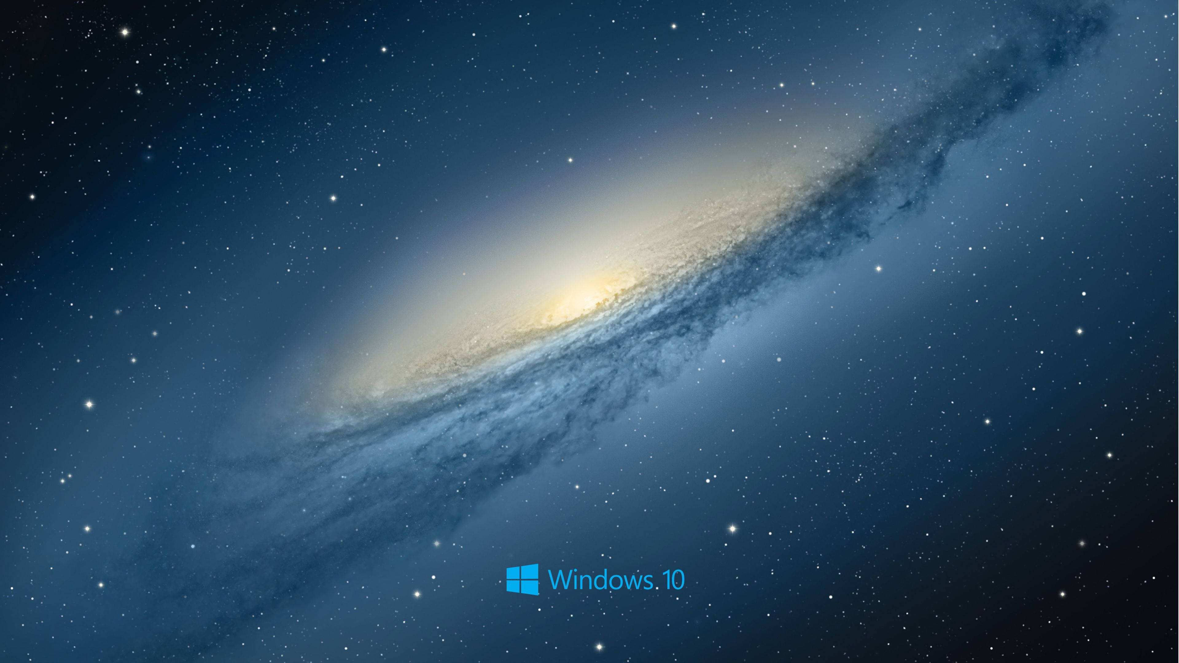 Windows 10 桌布 壁紙 — 一個令人嘆為觀止的螺旋星系，在深藍色星空中閃耀著金色光芒。