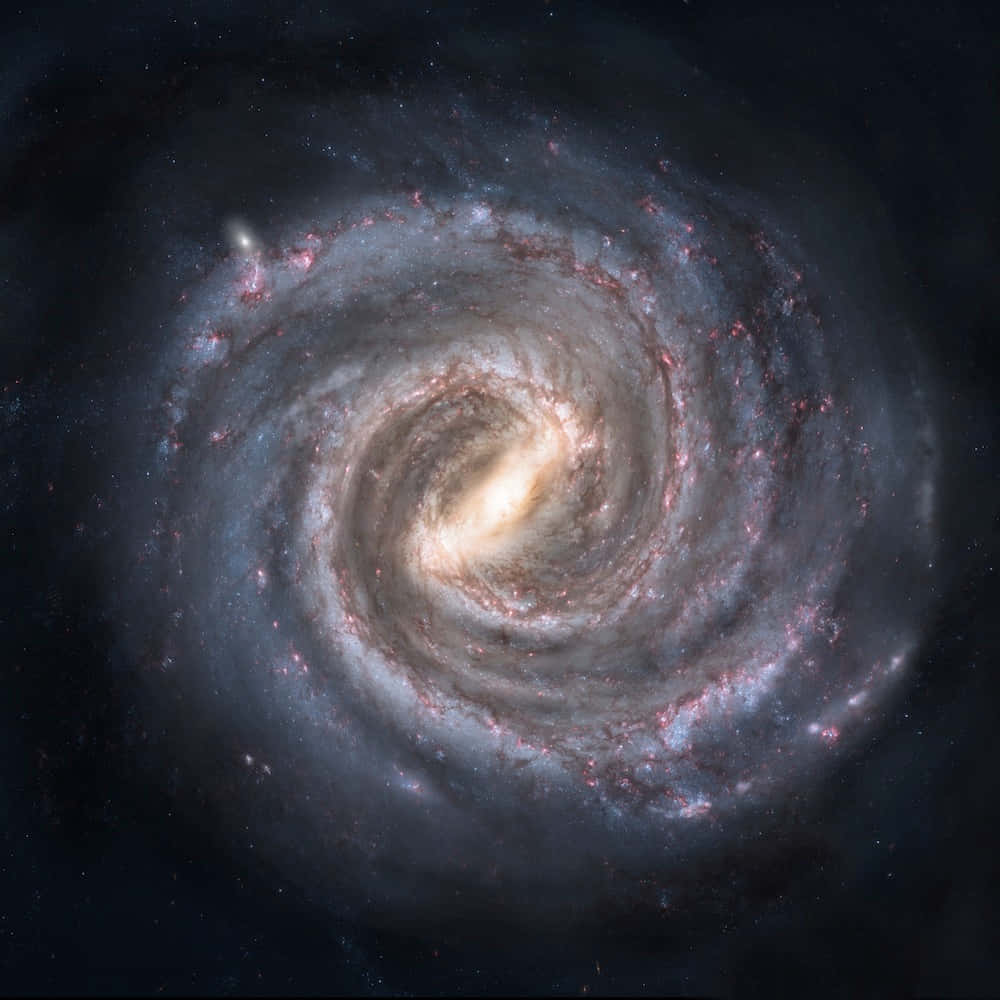 Elliptical Galaxy 桌布 壁紙 — 一個令人嘆為觀止的螺旋星系，在深邃的黑色宇宙虛空中旋轉著藍色和粉紅色恆星發光的旋臂。