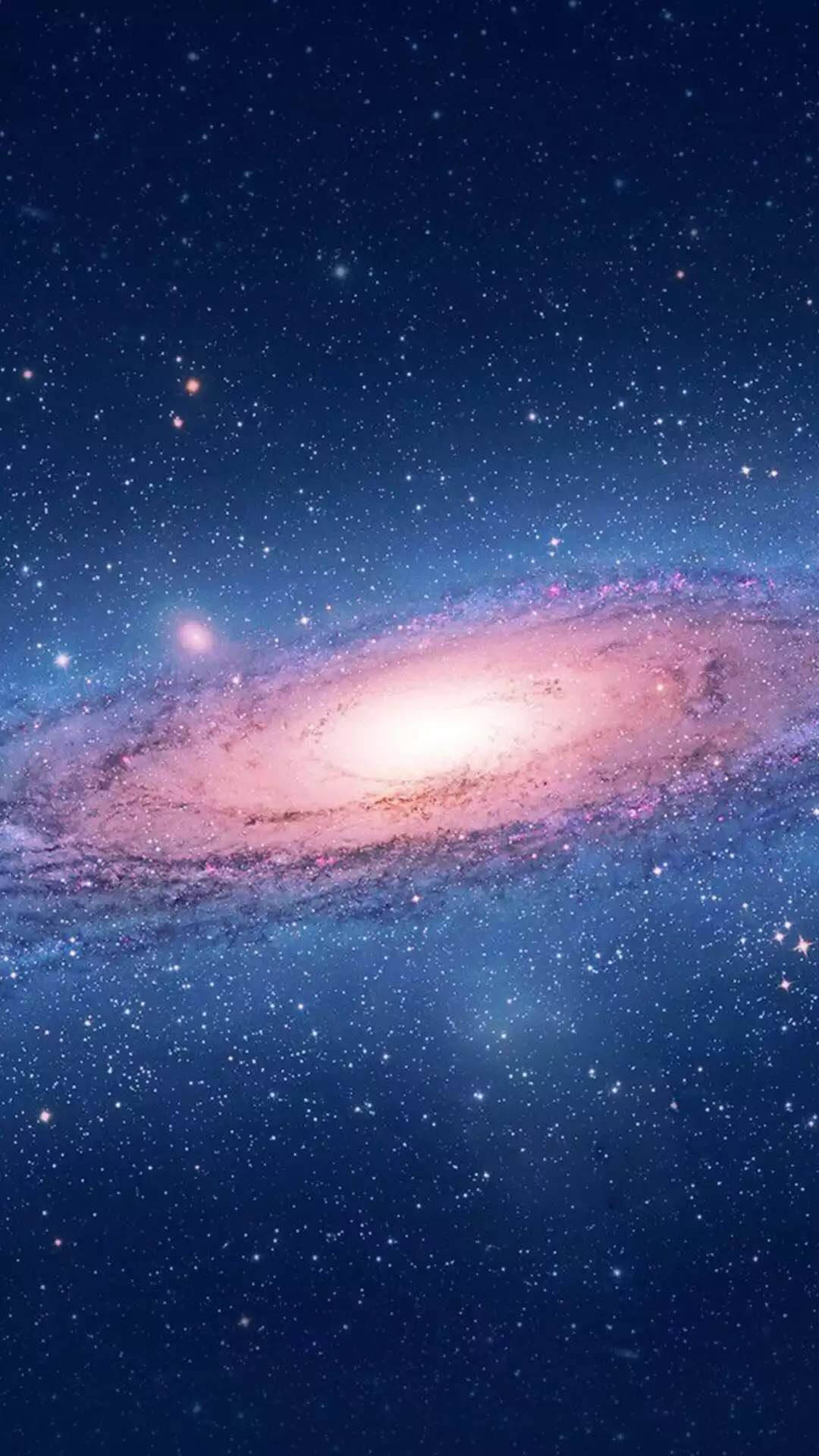 一個螺旋星系，其粉紅色和白色的旋臂在繁星點點的藍色天空中閃耀。 — 星雲 GIF 壁紙