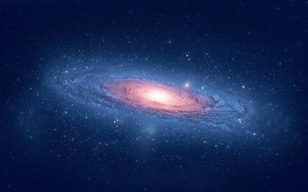 Mac Os 桌布 壁紙 — 一個令人嘆為觀止的螺旋星系，在繁星點點的宇宙背景下散發出粉紅色和藍色的色調。