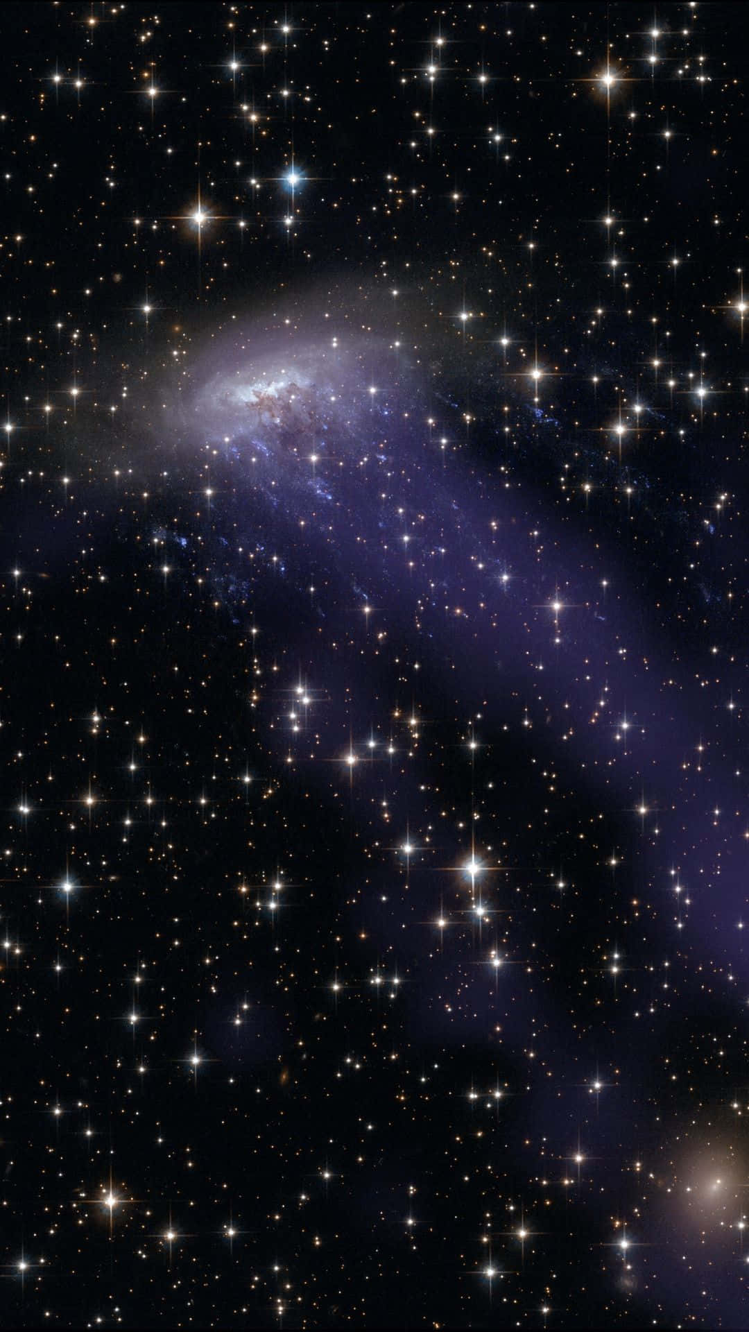 Starry Night Sky 桌布 壁紙 — 一個令人嘆為觀止的螺旋星系景象，散發著紫色和藍色色調，被無數閃爍的星星包圍，背景是深邃的黑色宇宙。