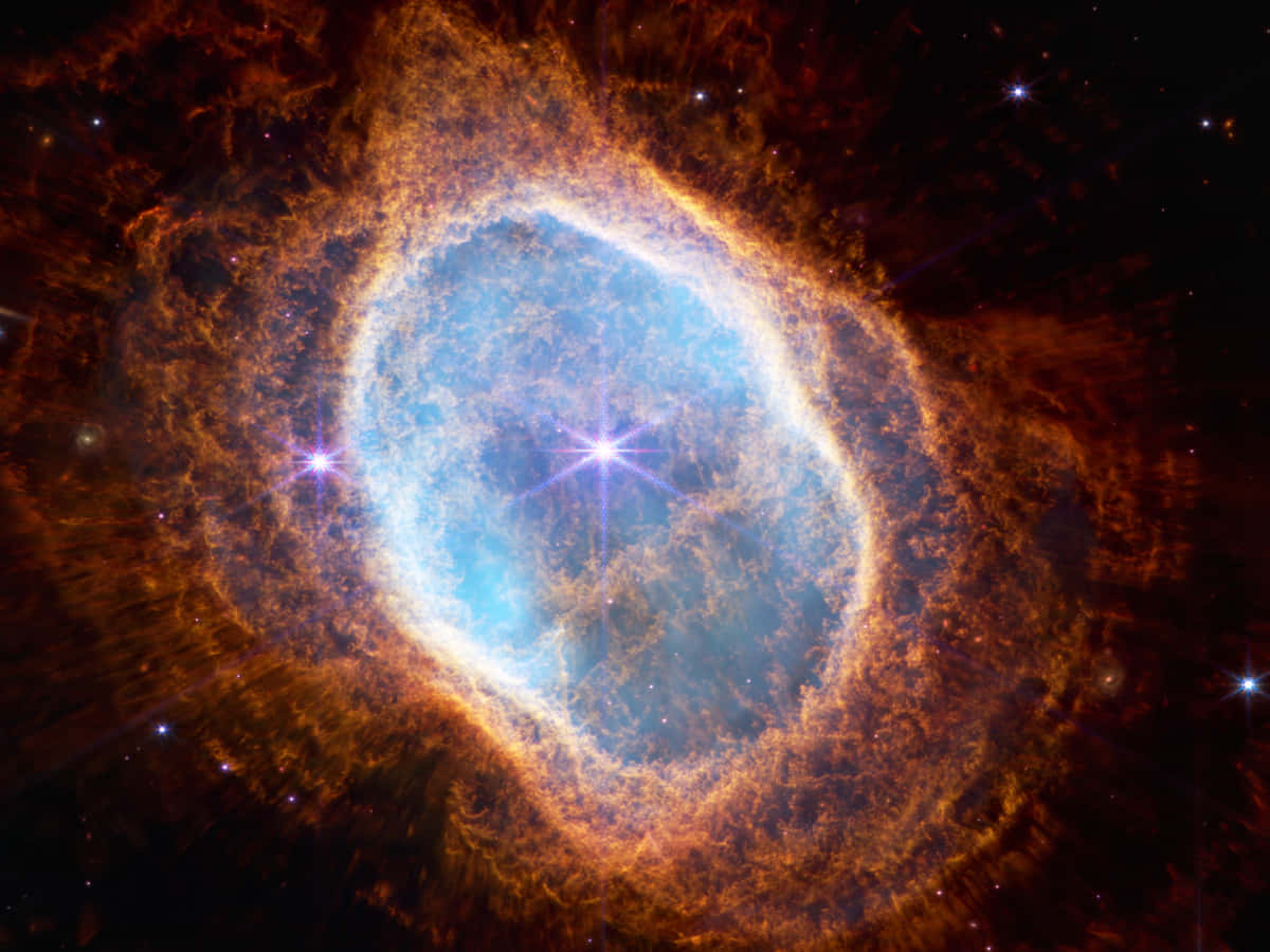 Stars 桌布 壁紙 — 一個令人驚嘆的宇宙星雲，中心明亮藍色，周圍環繞著熾熱的橙色卷鬚，背景是繁星點點的黑色虛空。