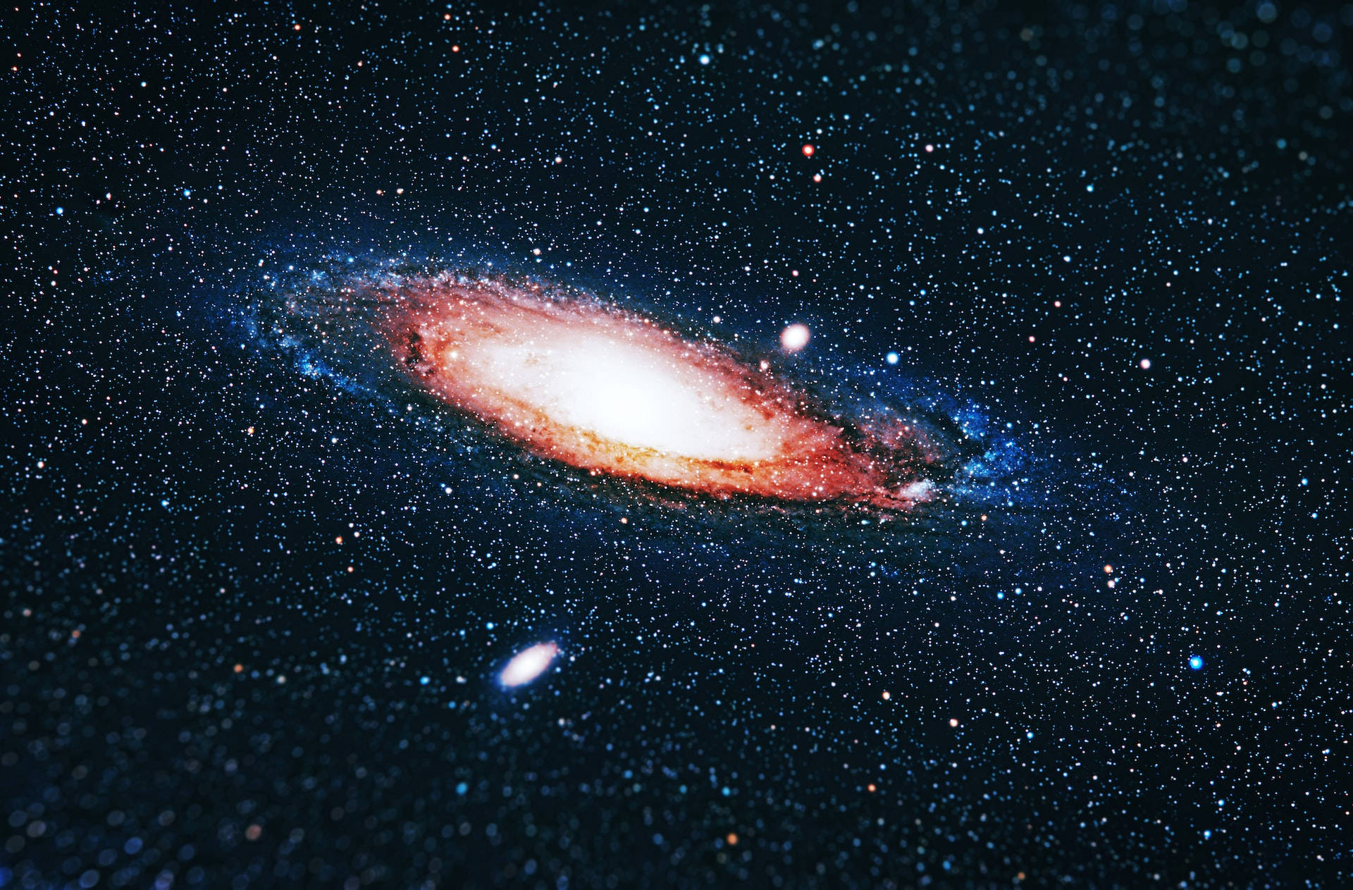 一個螺旋星系，帶有發光的旋臂和散落在深空中的星星。 — 外太空 GIF 壁紙