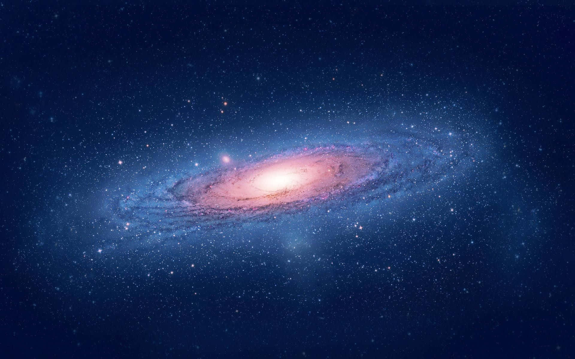 Whirlpool Galaxy 桌布 壁紙 — 一個令人驚嘆的螺旋星系，在繁星點點的宇宙背景下散發出粉紅色和藍色的光芒。
