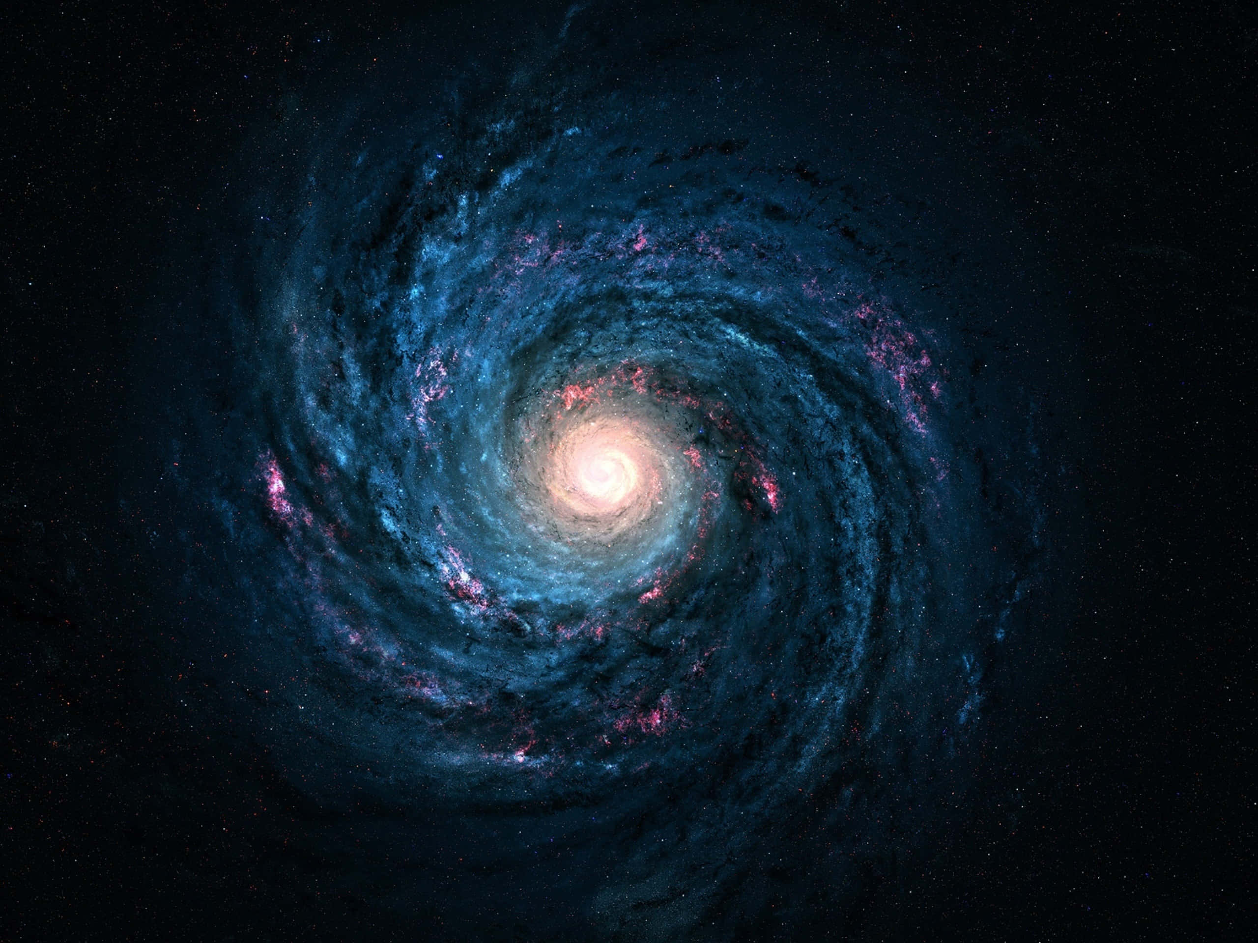 Beautiful Space 桌布 壁紙 — 一個令人驚嘆的螺旋星系，帶有發光的藍色旋臂和粉紅色星雲，圍繞著明亮的中心核心在佈滿星星的黑色虛空中旋轉。