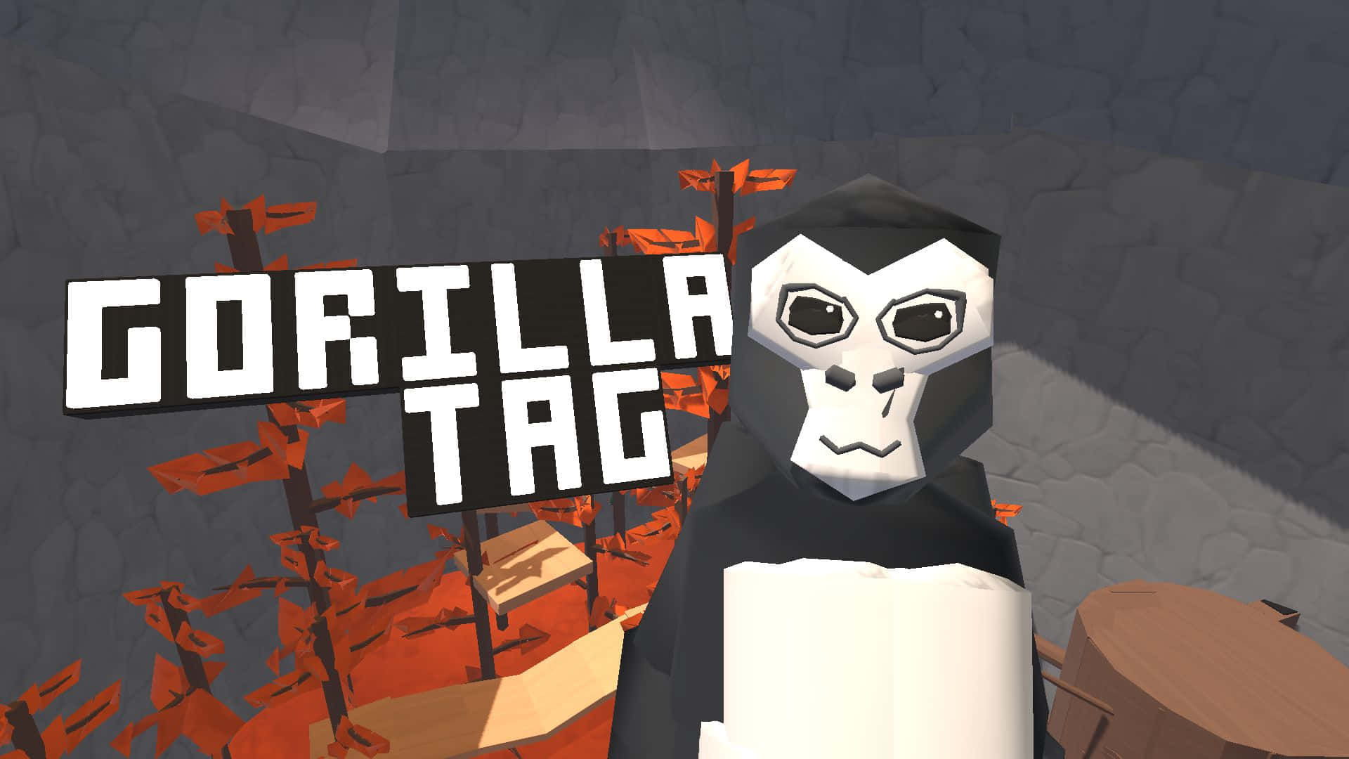 Gorilla Tag 桌布 壁紙 — 一個低多邊形大猩猩角色站在一個「GORILLA TAG」標誌前，身處一個方塊狀的遊戲環境，有橙色結構和灰色石牆。