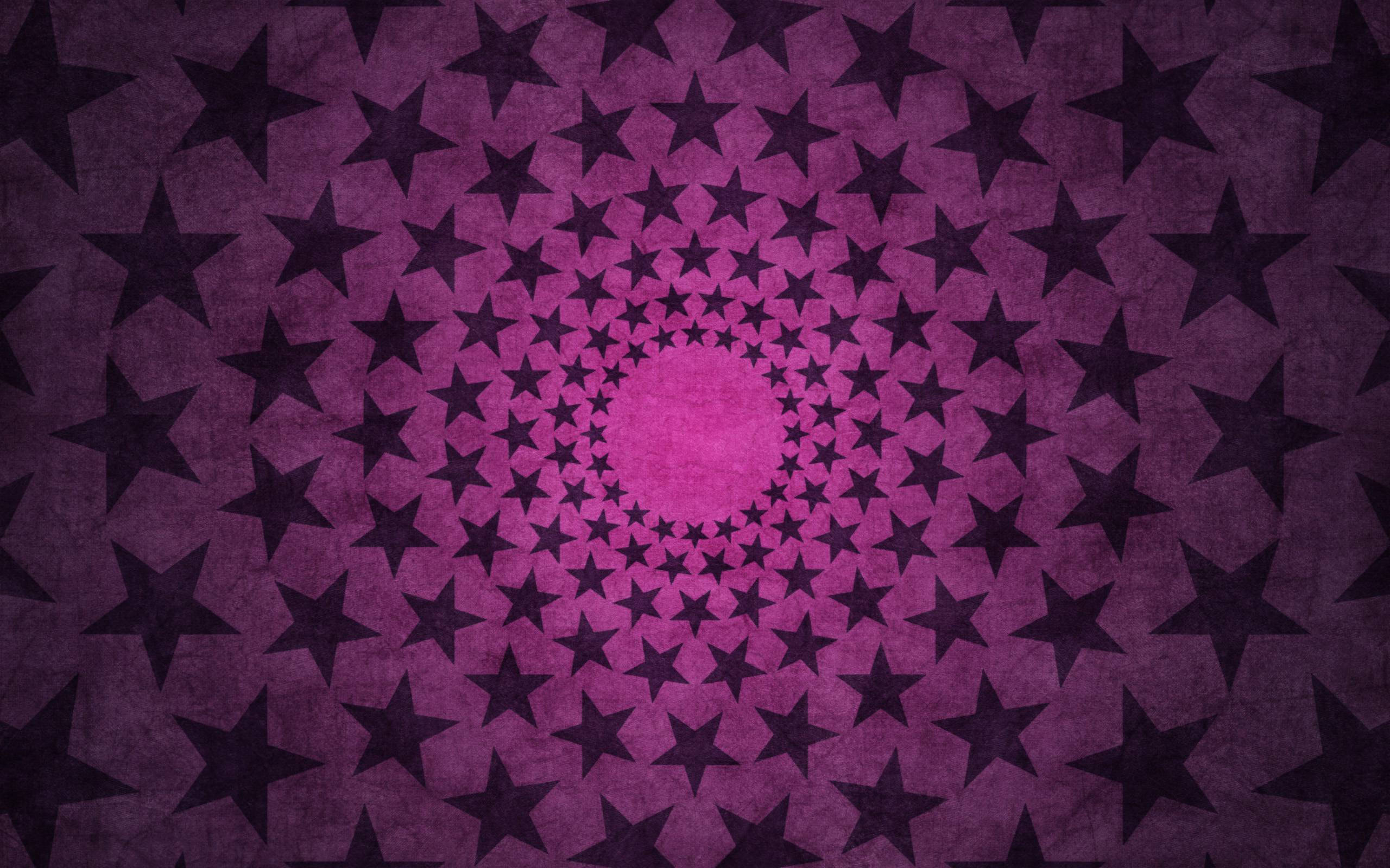 Cool Cute 桌布 壁紙 — 一個催眠般的黑暗星星螺旋從發光的粉紅色中心向帶有紋理的紫色背景輻射。