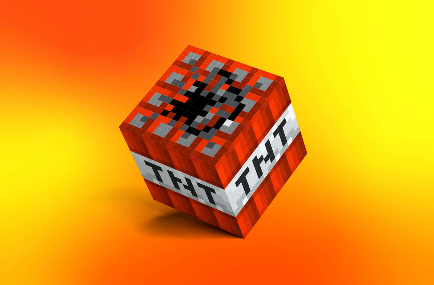 遊戲 桌布 壁紙 — 一個像素化的Minecraft TNT方塊，帶有黑色引信，在充滿活力的橙色和黃色漸變背景上發光。