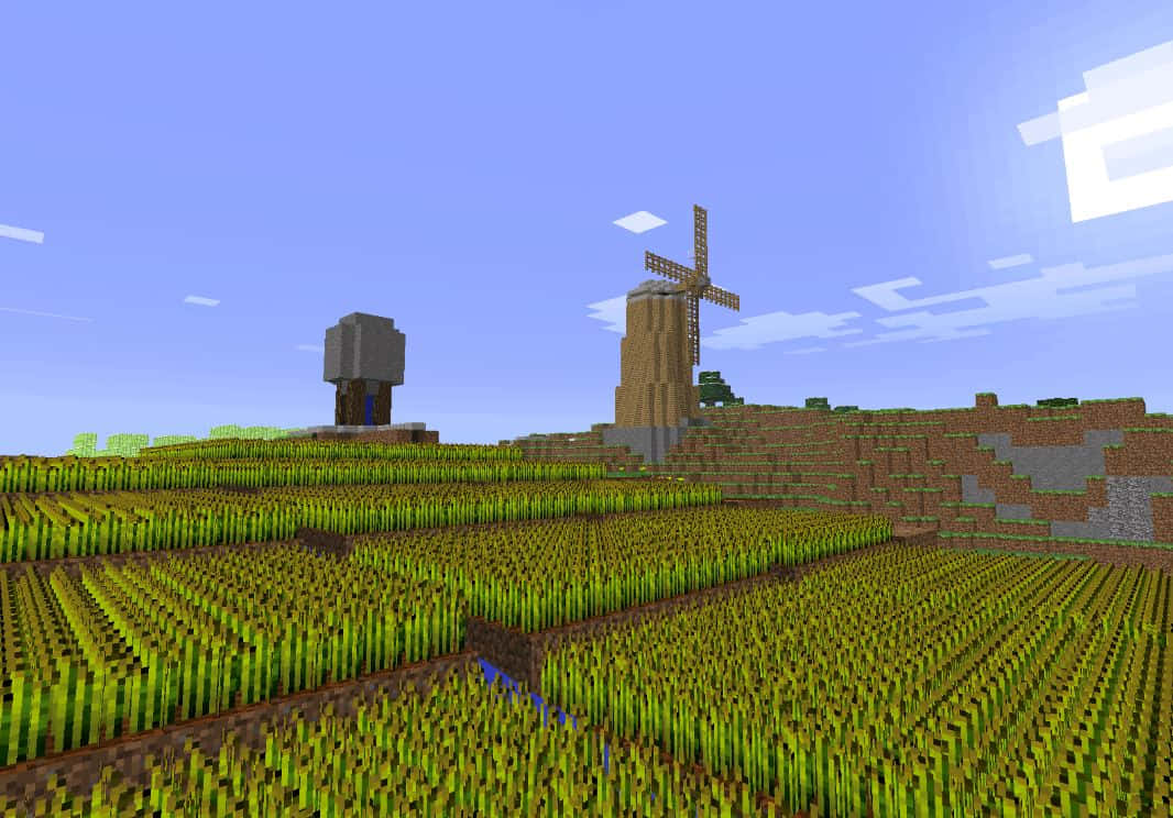 Minecraft Pixel Art 桌布 壁紙 — 一個像素化的Minecraft景觀，在晴朗的藍天下，起伏的綠色山丘上有一座風車和石結構。