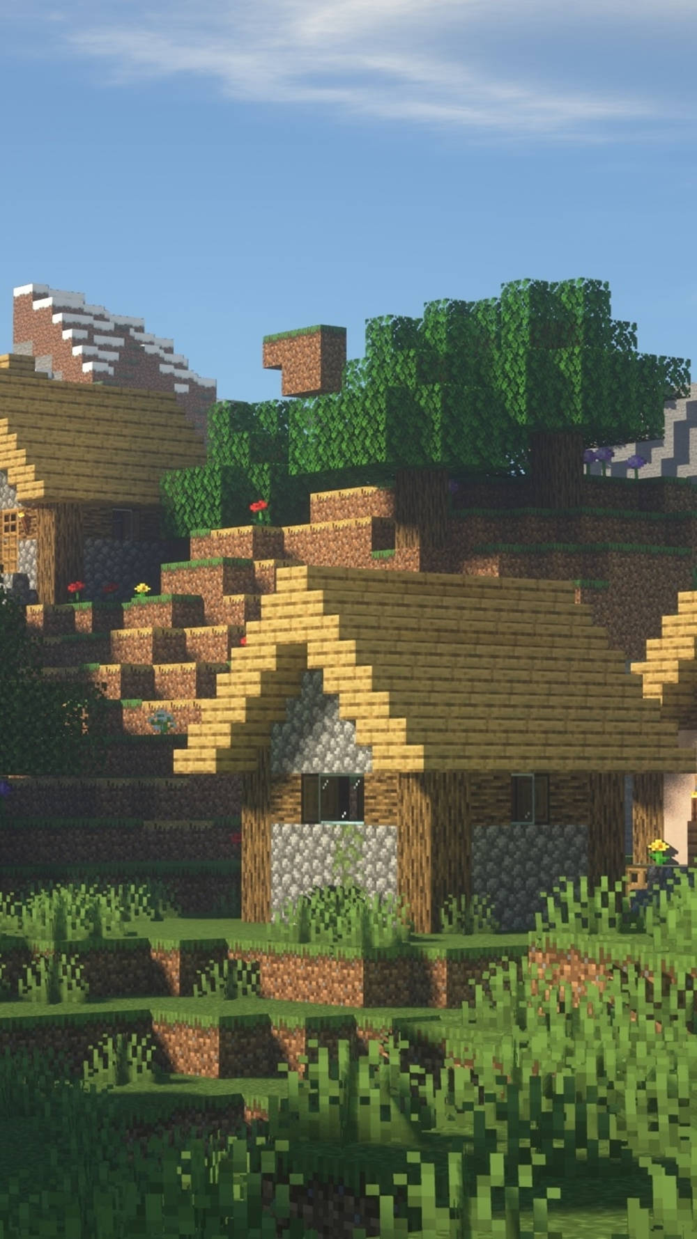 我的世界 高畫質壁紙 桌布 壁紙 — 一個像素化的Minecraft村莊，有木屋、石頭地基和綠樹，在晴朗的藍天下。