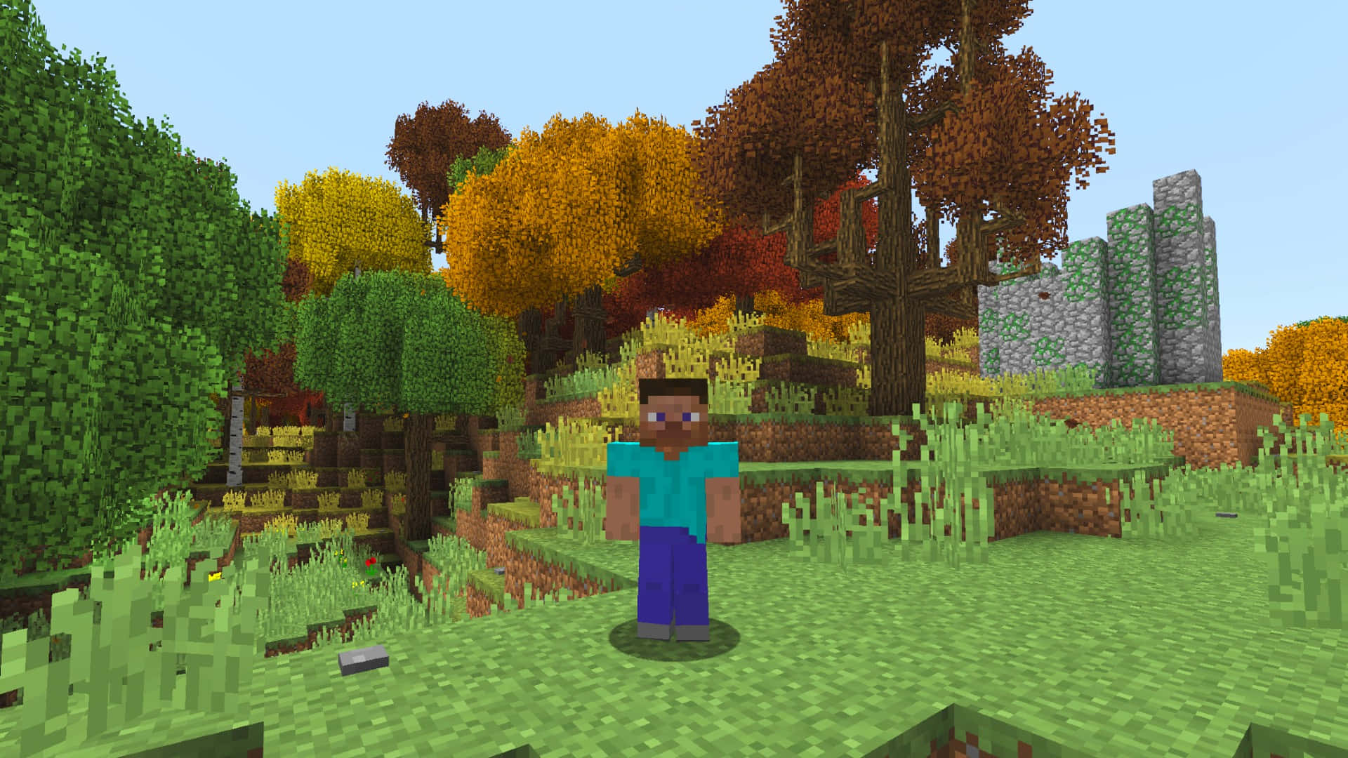 Minecraft Mods 桌布 壁紙 — 一個像素化的Minecraft角色站在充滿活力的秋日森林中，周圍是色彩繽紛的樹木和草地，天空晴朗。