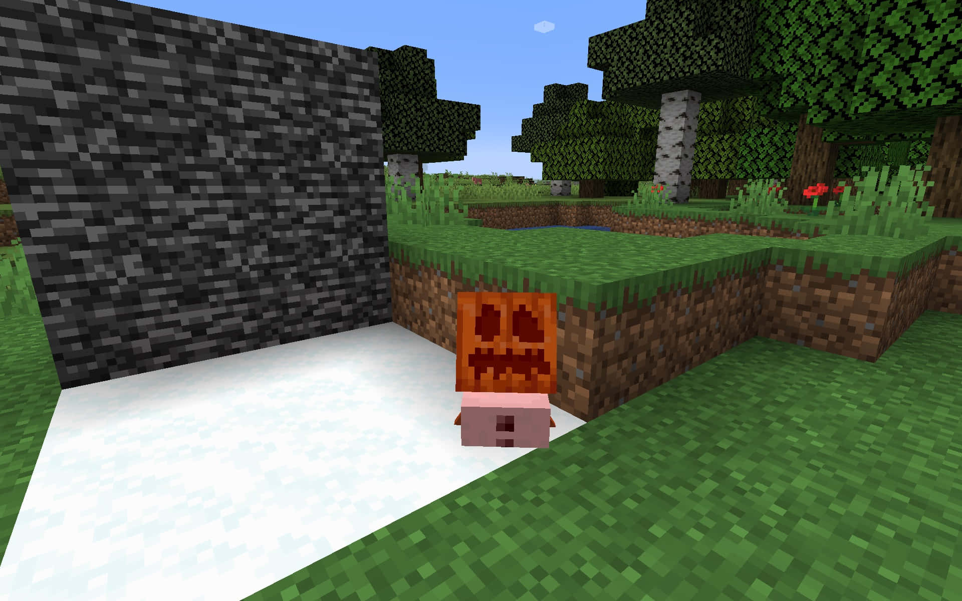 Minecraft Snow Golem 桌布 壁紙 — 一個像素化的南瓜燈放在Minecraft森林生物群系的雪地上，旁邊有一道石牆。