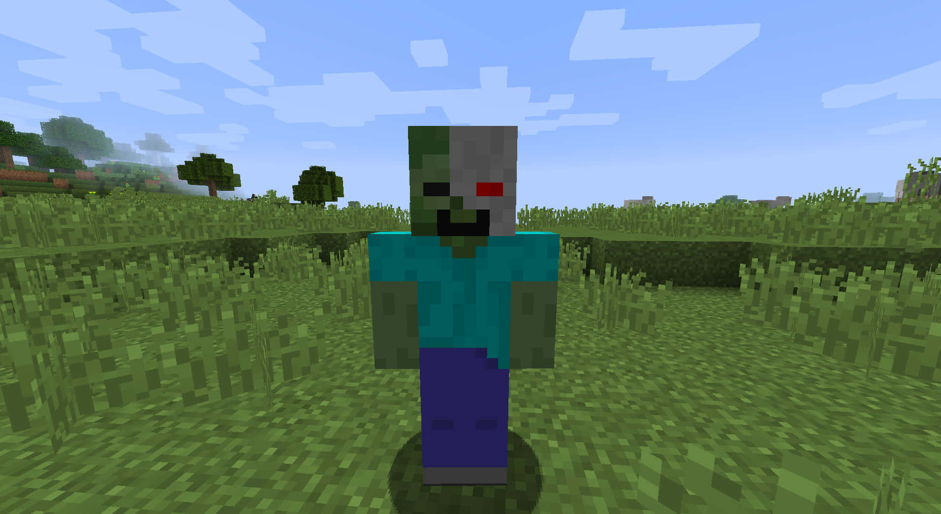 Minecraft Zombie 桌布 壁紙 — 一個像素化的殭屍站在Minecraft中藍天白雲下的草地上。