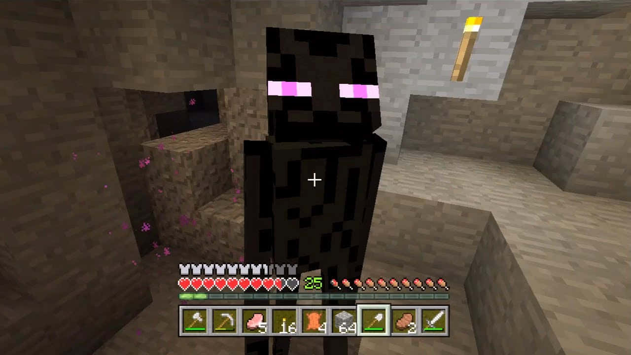 Ender Dragon 桌布 壁紙 — 一個像素化的終界使者站在光線昏暗的Minecraft洞穴中，周圍漂浮著發光的粉紅色粒子。