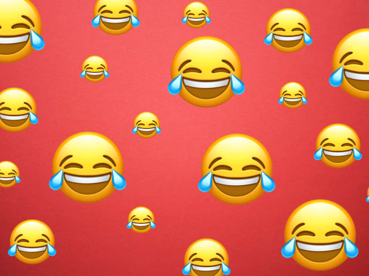 Laughing 桌布 壁紙 — 一個充滿各種大小重複笑哭表情符號臉孔的鮮紅色背景。