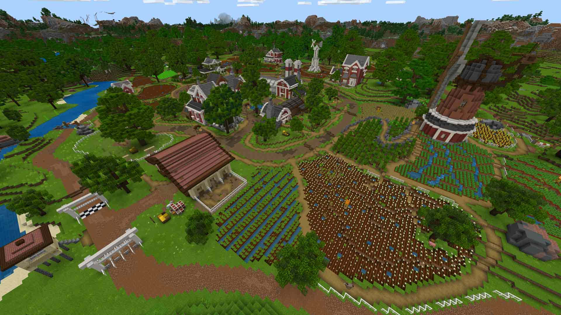Minecraft Farming 桌布 壁紙 — 一個充滿活力的Minecraft村莊坐落在鬱鬱蔥蔥的綠色山谷中，有農場、河流和風車，在清澈的藍天下。