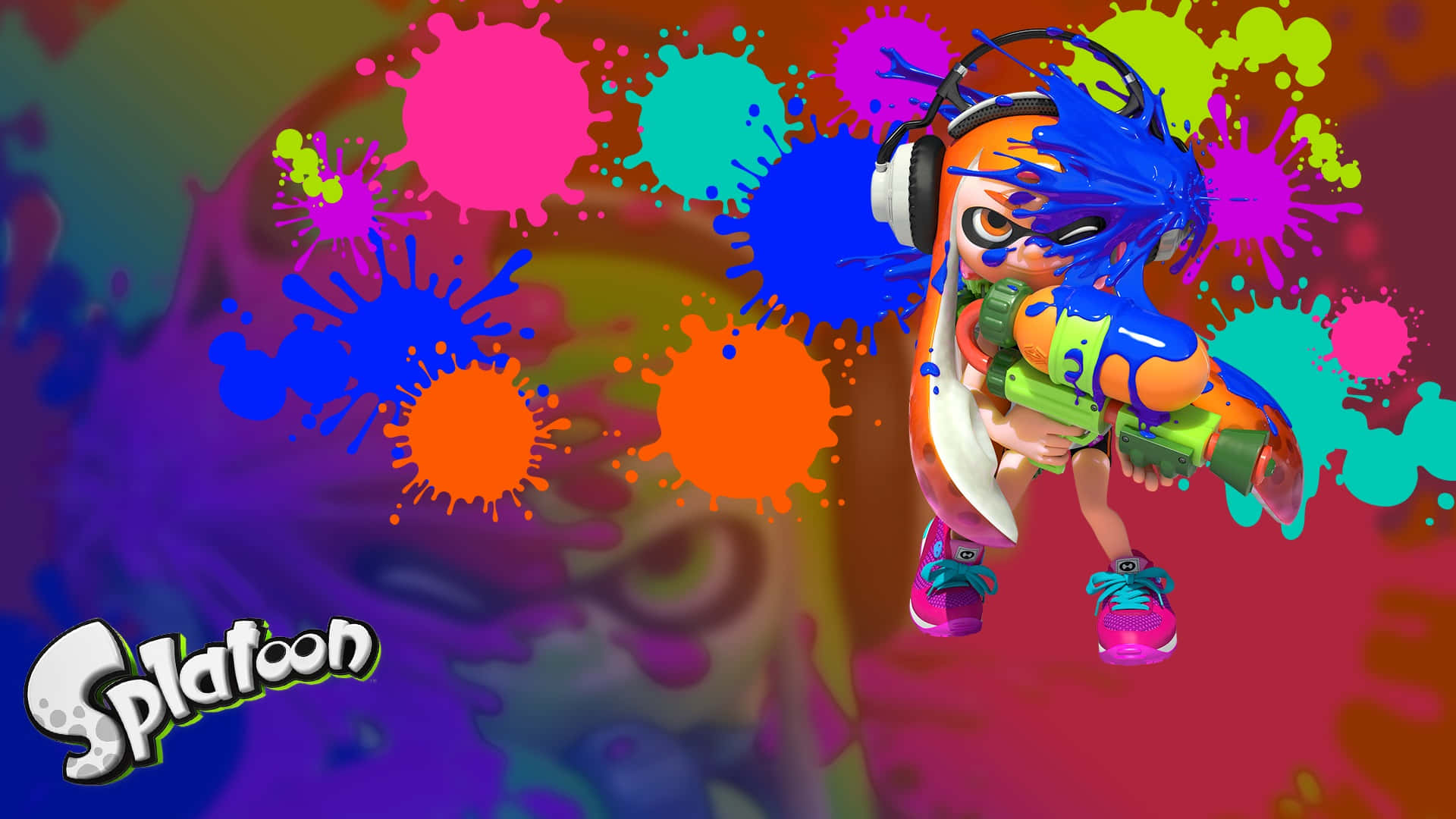 splatoon 2 桌布 壁紙 — 一個充滿活力的Splatoon角色正在行動中，周圍環繞著色彩繽紛的墨水飛濺，背景是動態漸變。