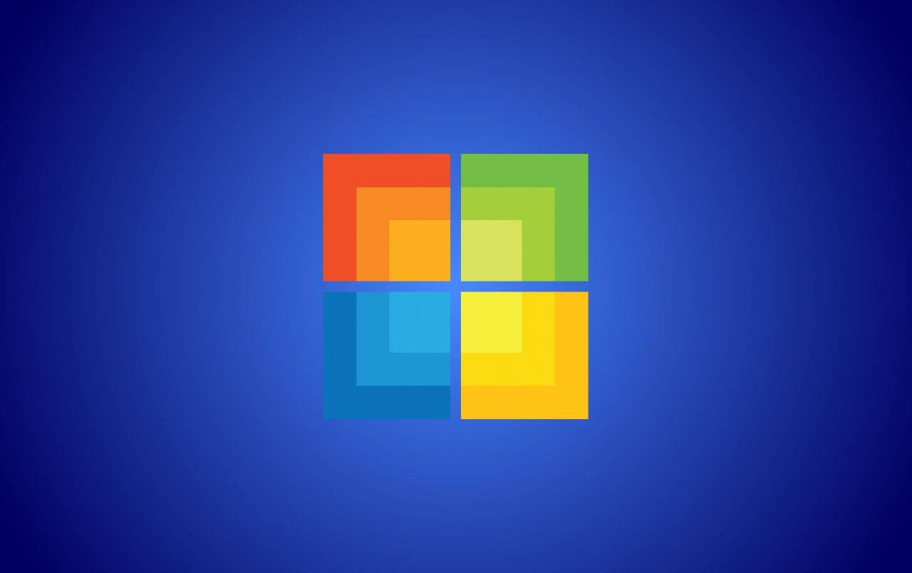 Windows標誌，在藍色漸變背景上有彩色方塊 — Microsoft 壁紙