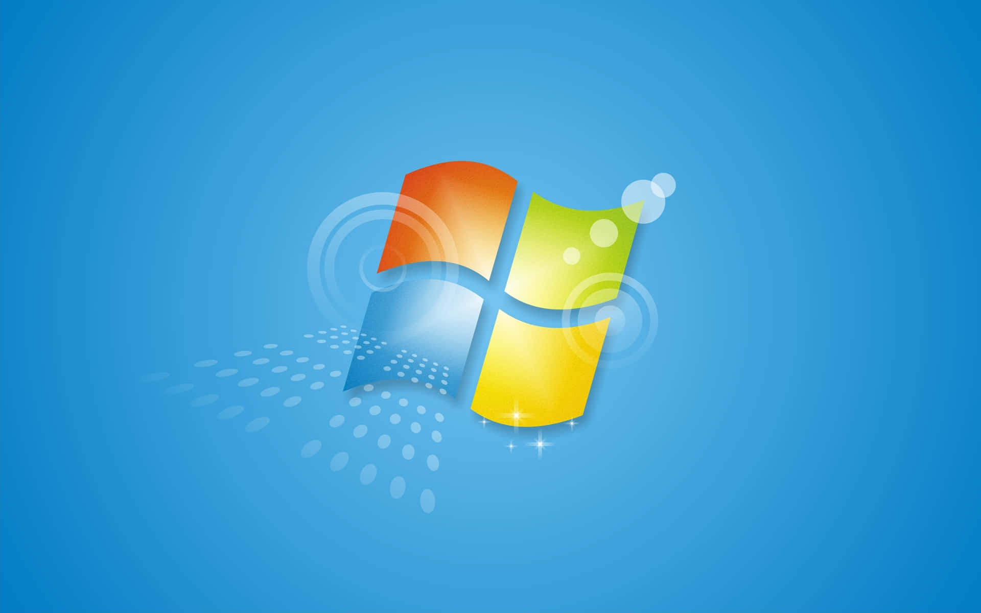 Windows 7 桌布 壁紙 — 一個充滿活力的Windows標誌，帶有橙色、綠色、藍色和黃色窗格，漂浮在帶有微妙光效的純藍色背景上。