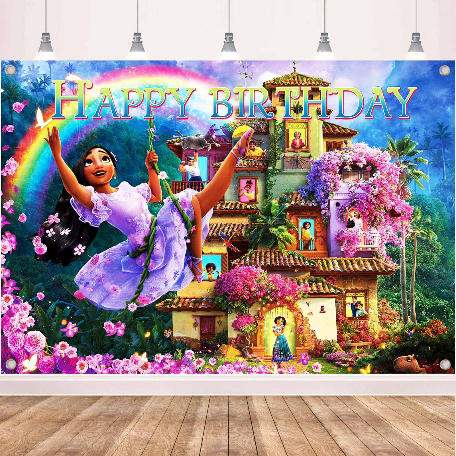 Encanto 桌布 壁紙 — 一個充滿活力的動畫生日背景，描繪一個快樂的女孩在彩虹下盪鞦韆，旁邊有色彩繽紛的墨西哥風格房屋和盛開的花朵。