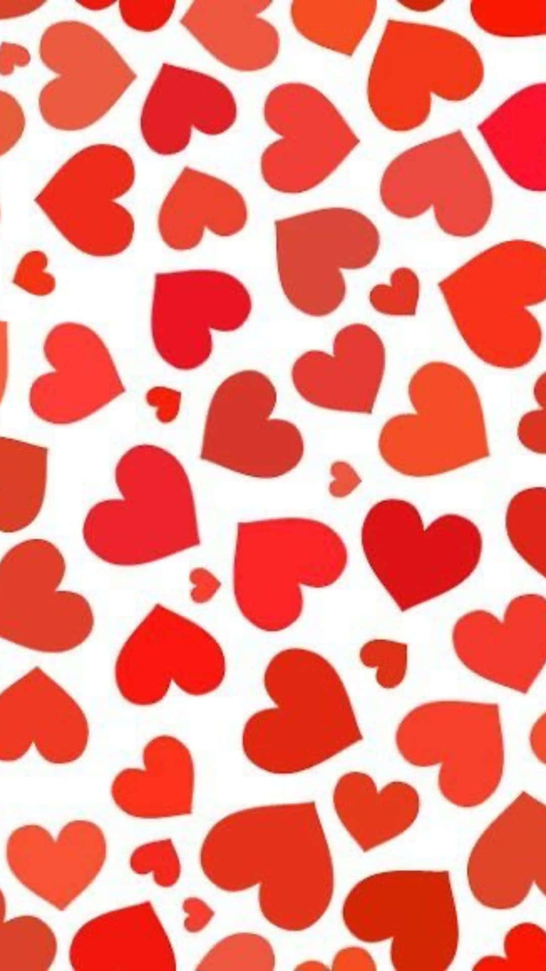 Red Hearts 桌布 壁紙 — 一個充滿活力的圖案，由各種大小的紅色心形散落在潔淨的白色背景上。