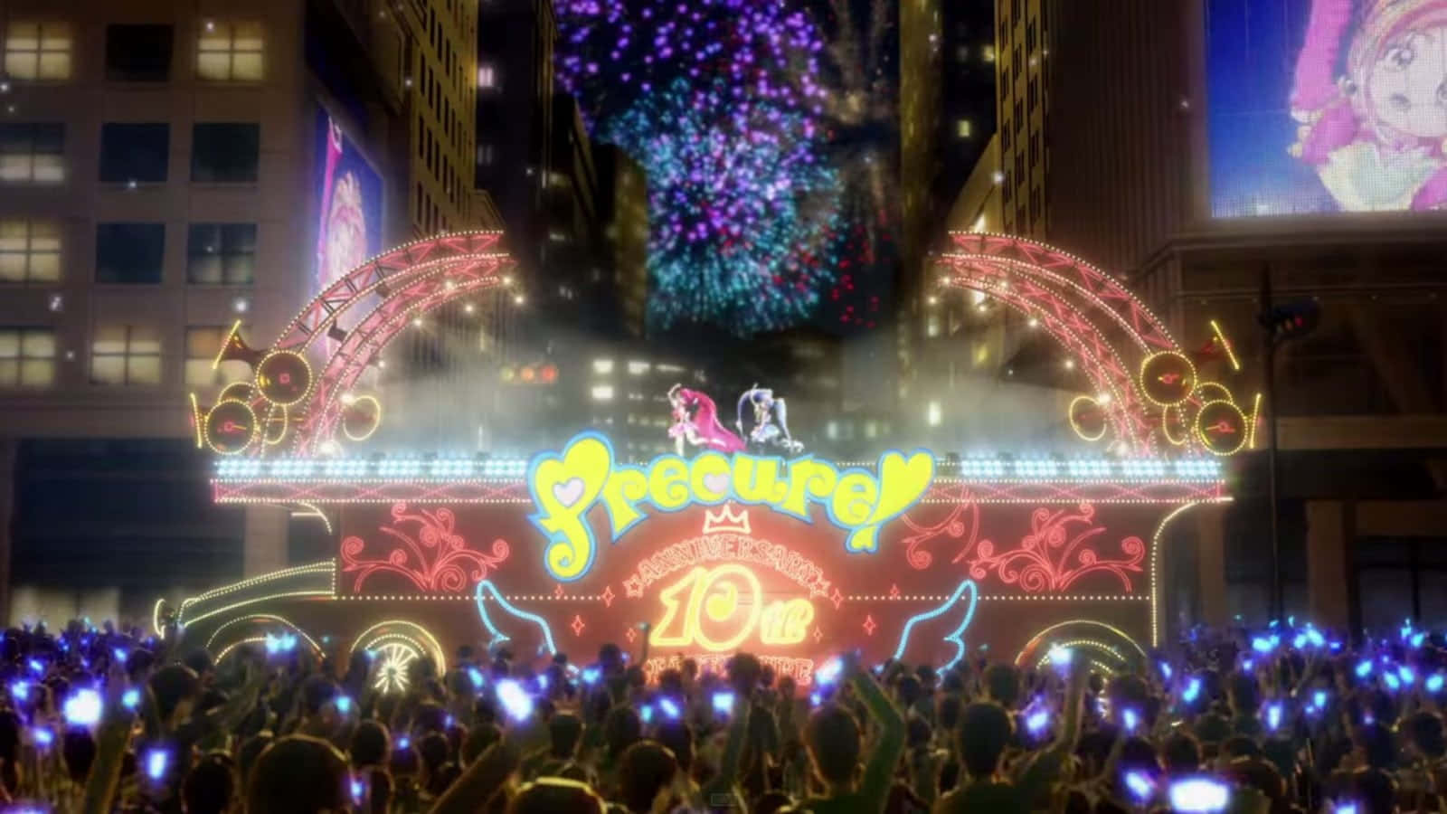 動漫 桌布 壁紙 — 一個充滿活力的夜間遊行花車，帶有 'Precure' 品牌和發光燈光，周圍是舉著藍色手機的歡呼人群。