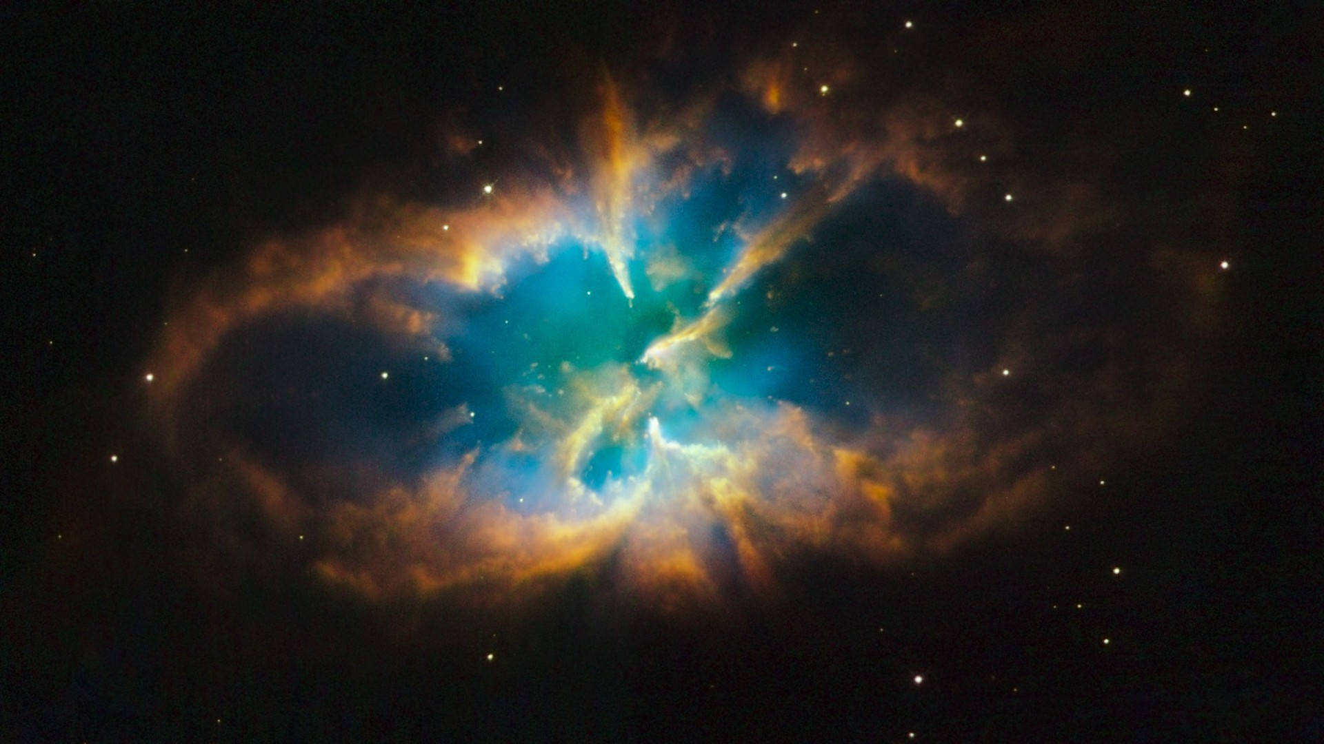 宇宙 桌布 壁紙 — 一個充滿活力的宇宙星雲，在佈滿星星的黑色虛空中散發著藍綠色和琥珀色的光芒。