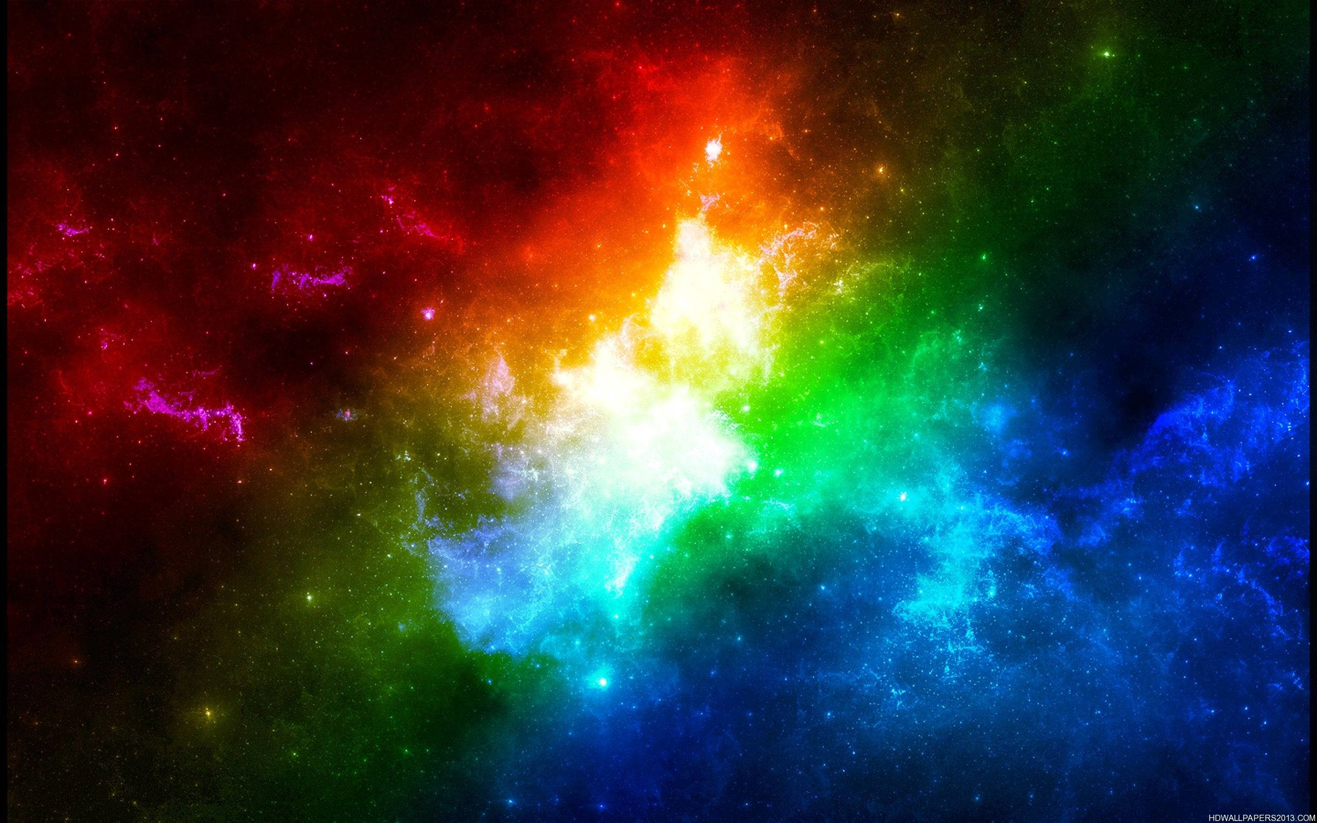 彩色動圖 桌布 壁紙 — 一個充滿活力的宇宙星雲，在佈滿星星的虛空中爆發著燦爛的彩虹色調。