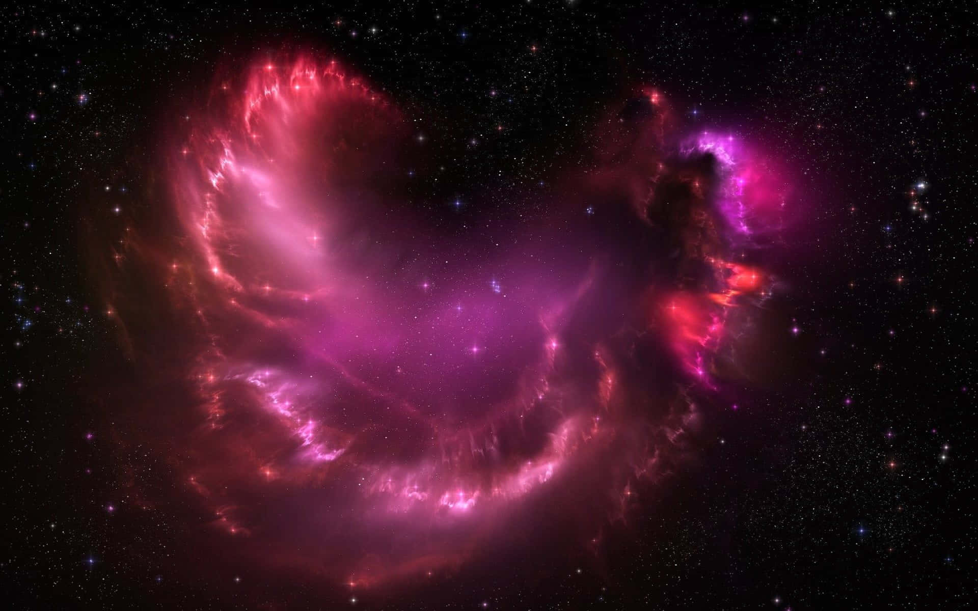 粉紅銀河 桌布 壁紙 — 一個充滿活力的宇宙星雲，在深空的星場背景下，散發著旋轉的粉紅色和紅色氣體的光芒。