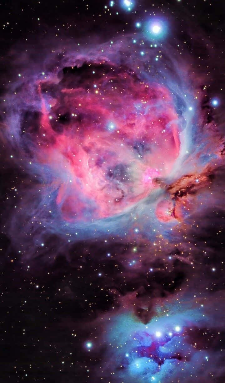 在深空中閃耀著星星的充滿活力的粉紅色、紫色和藍色星雲。 — 閃爍 GIF 壁紙