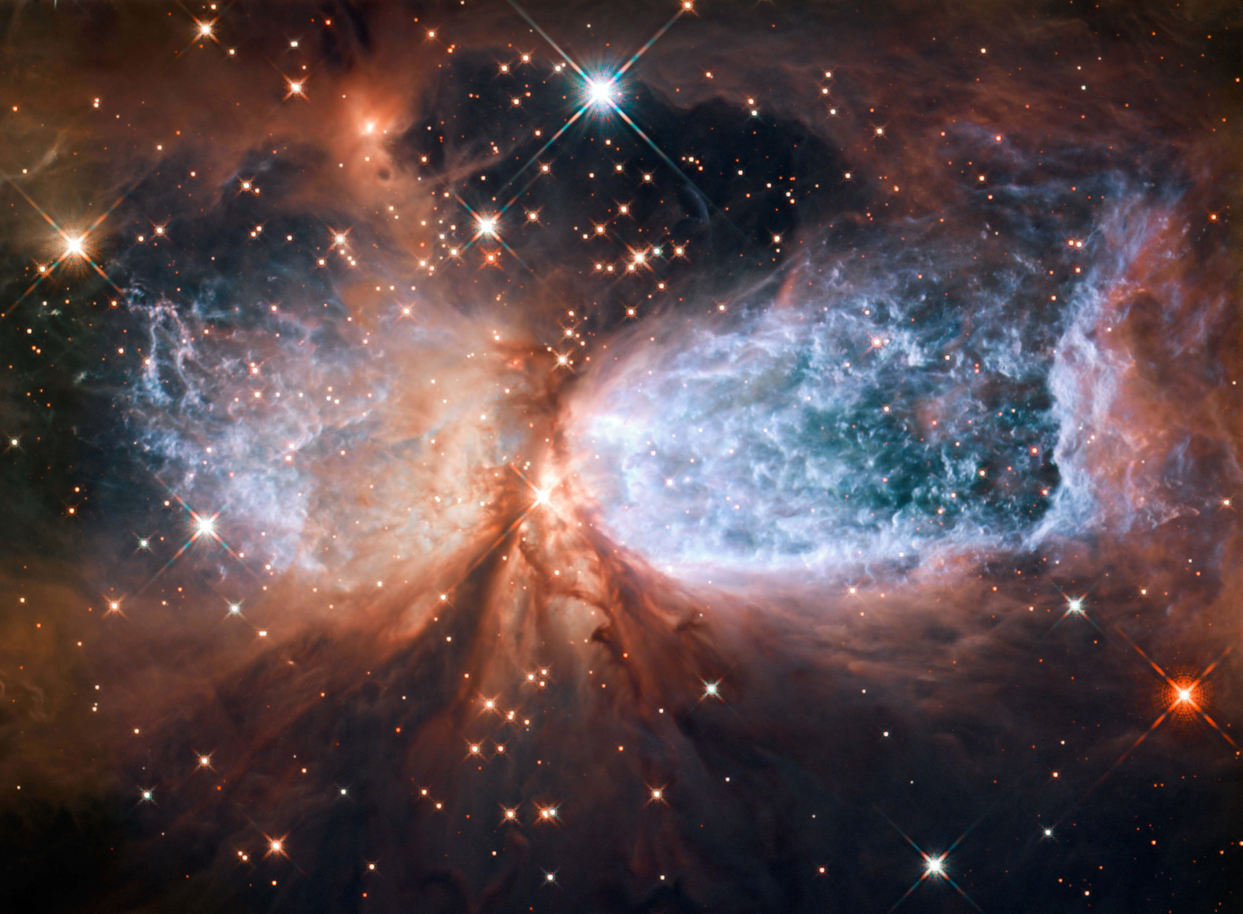 Telescope 桌布 壁紙 — 一個充滿活力的宇宙星雲，在黑暗虛空中由璀璨星辰照亮，呈現出藍色和橙色的發光雲層。