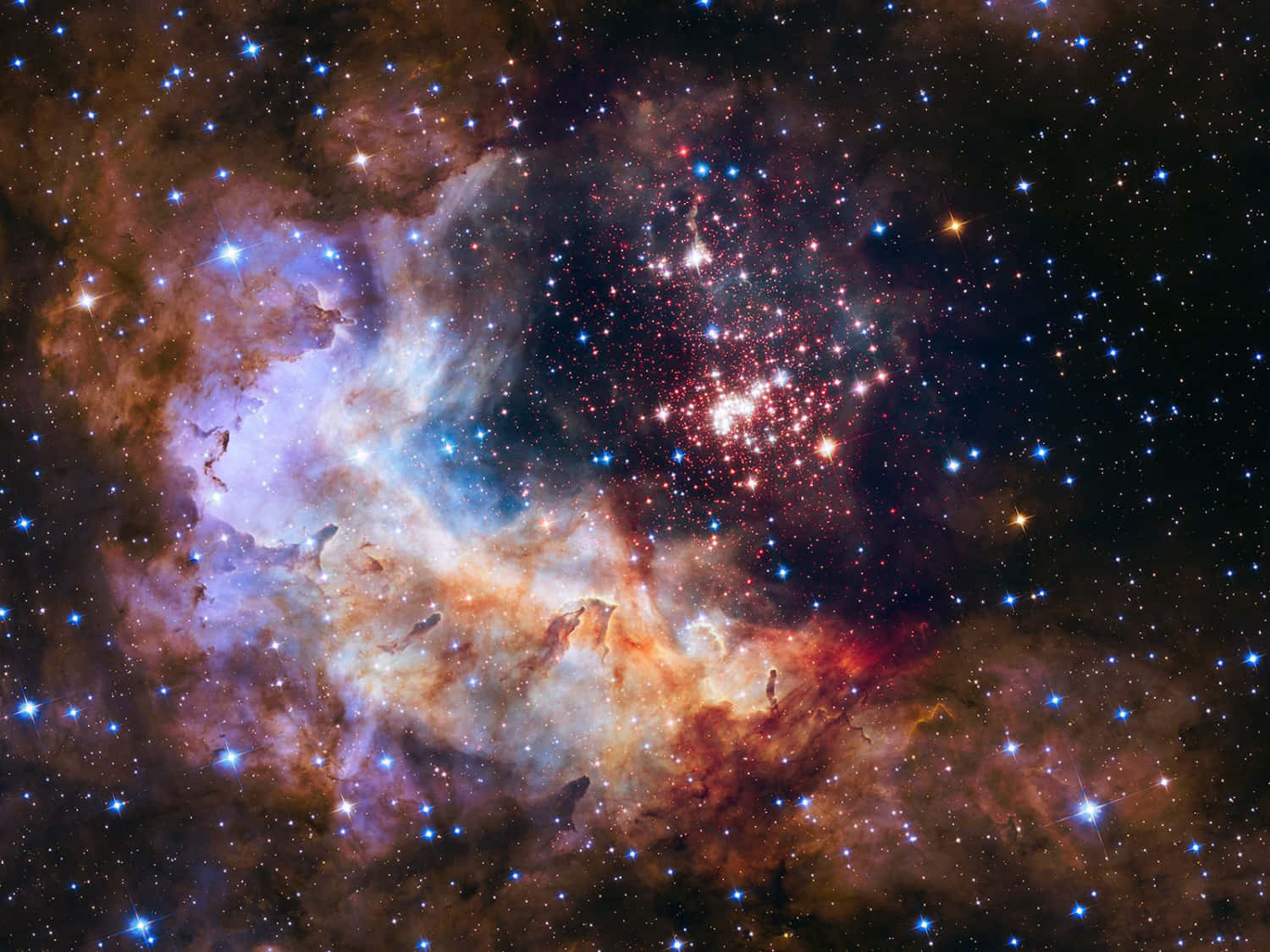 太空 桌布 壁紙 — 一個充滿活力的宇宙星雲，旋轉著發光的橙色、藍色和紫色氣體，周圍有無數閃爍的星星，背景是深邃的黑色虛空。
