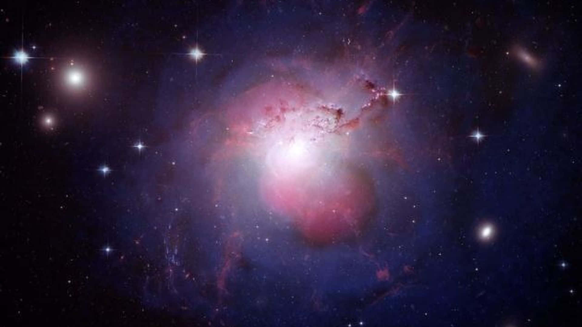 dark matter 桌布 壁紙 — 一個充滿活力的宇宙星雲在深空的星場中散發出粉紅色和藍色的光芒。