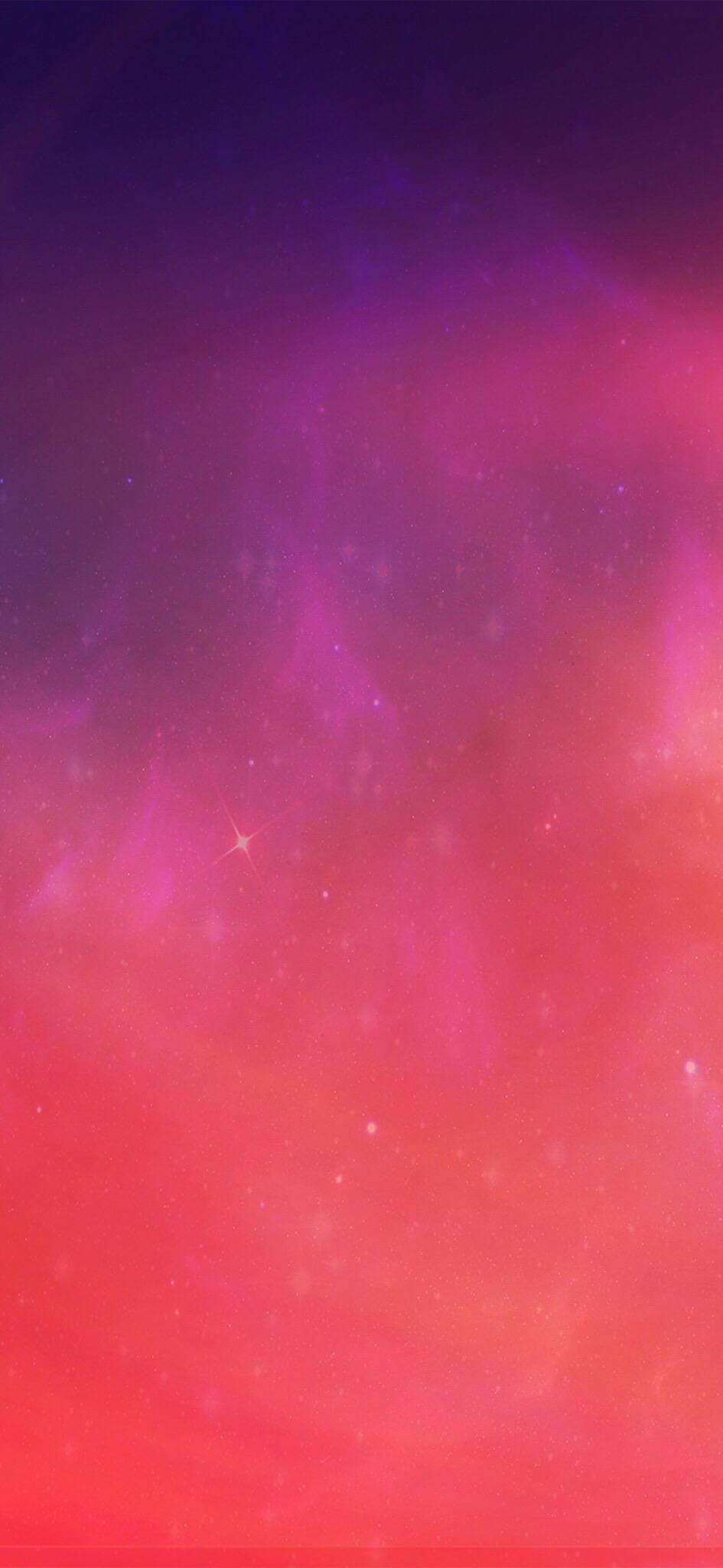 iOS 16 壁紙 桌布 壁紙 — 一個充滿活力的宇宙星雲在粉紅色、紫色和紅色的漸變中旋轉，散落著發光的星星，背景是黑暗的虛空。