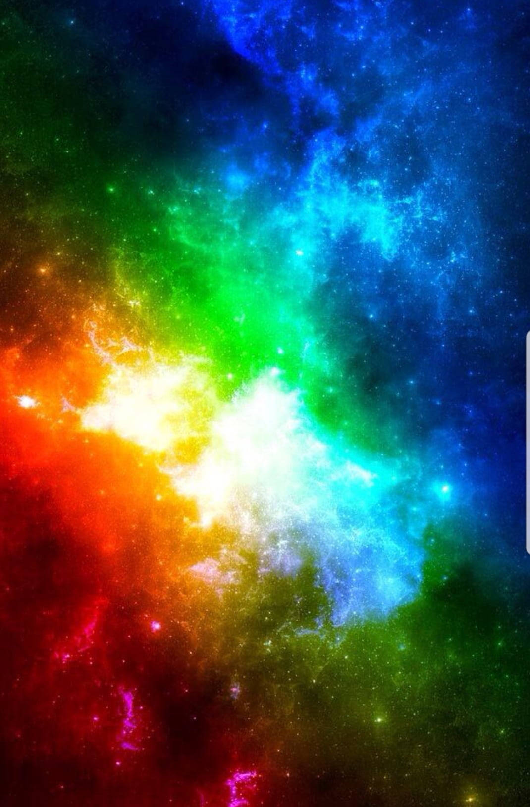 彩虹 桌布 壁紙 — 一個充滿活力的宇宙星雲在繁星點點的虛空中爆發，呈現出紅、橙、黃、綠、藍、紫的彩虹色調。