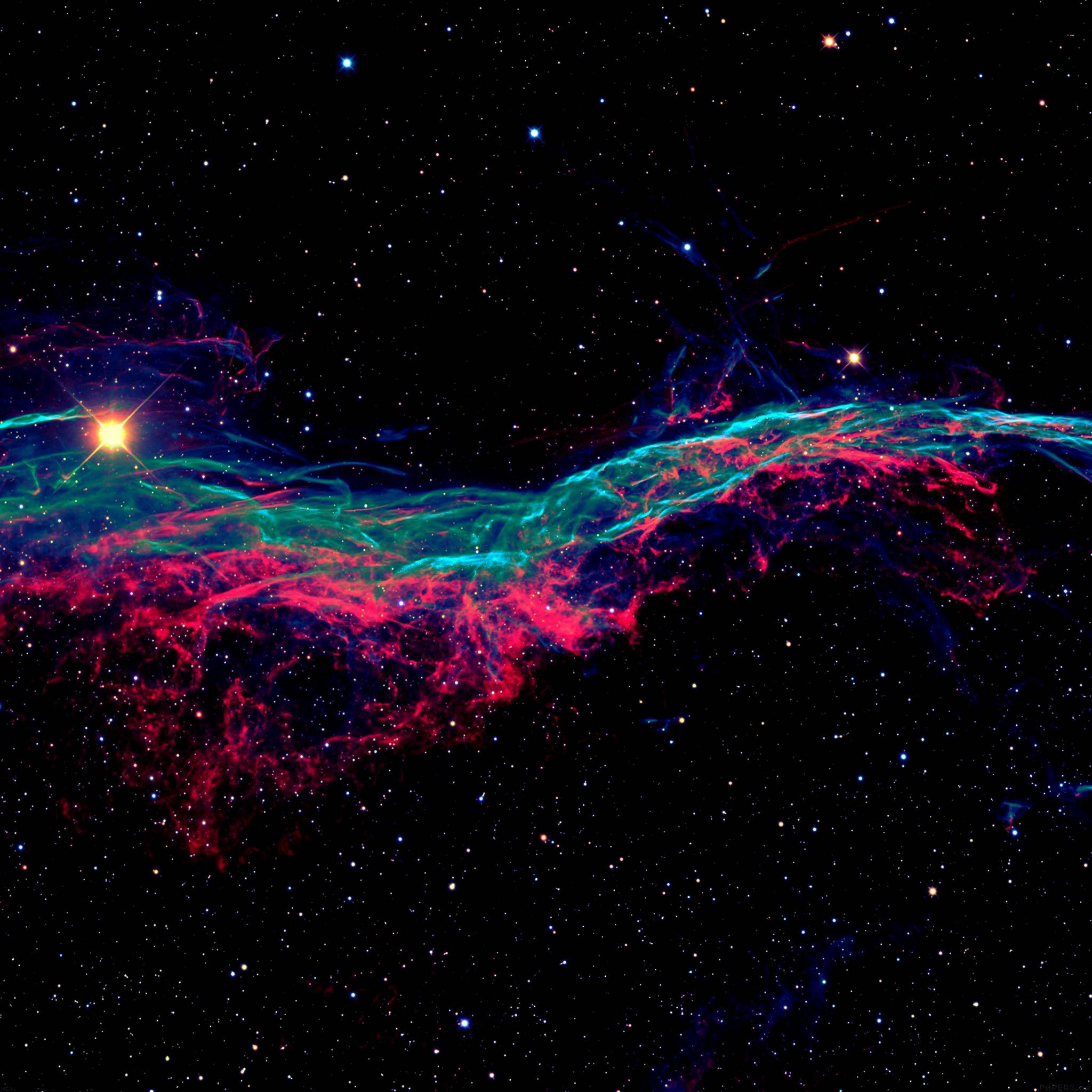 AMOLED 桌布 壁紙 — 一個充滿活力的宇宙星雲在電光粉紅和藍綠色中旋轉，背景是星空，中央有一顆明亮的恆星。